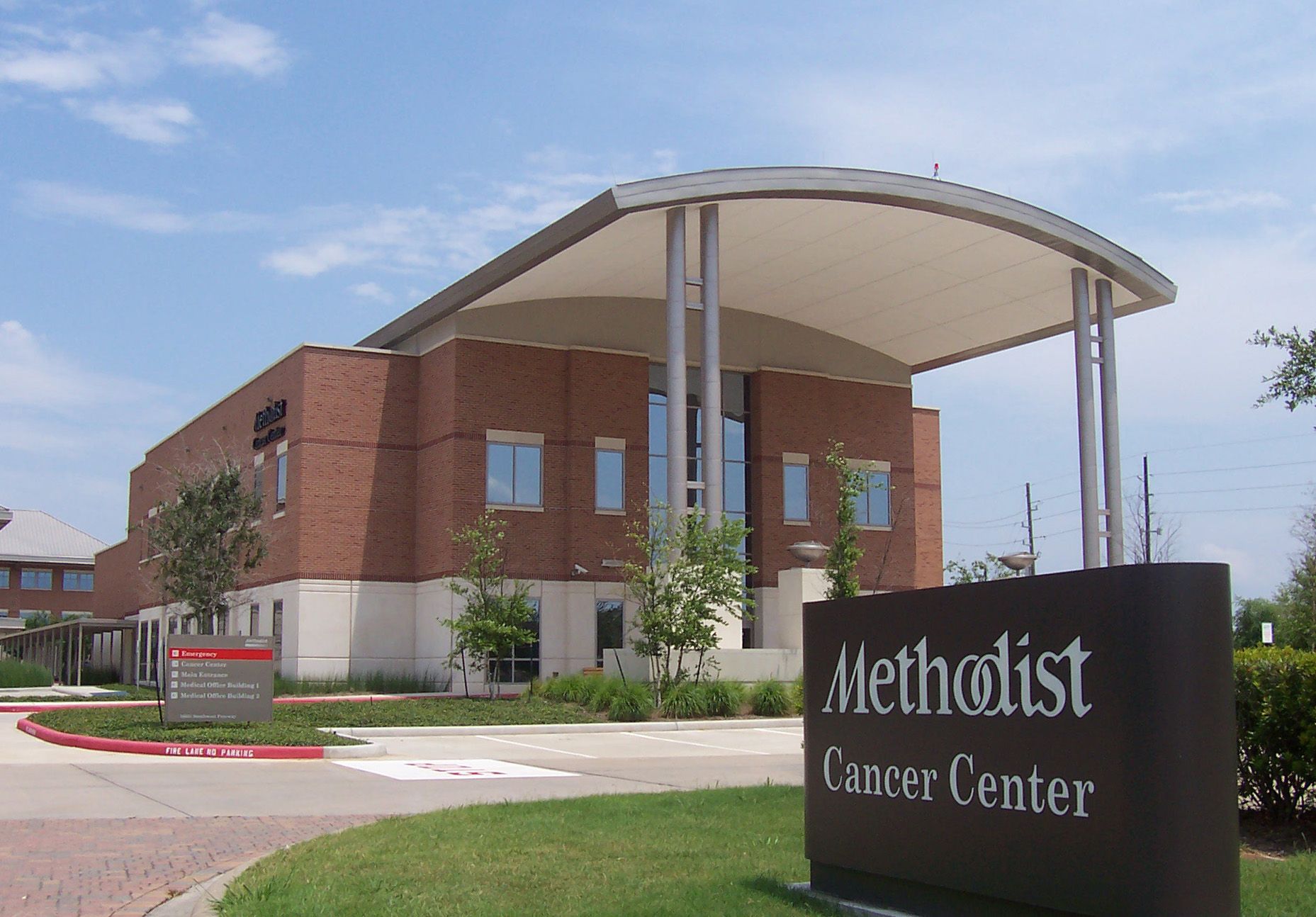 A large brick building with a sign that says methodist cancer center