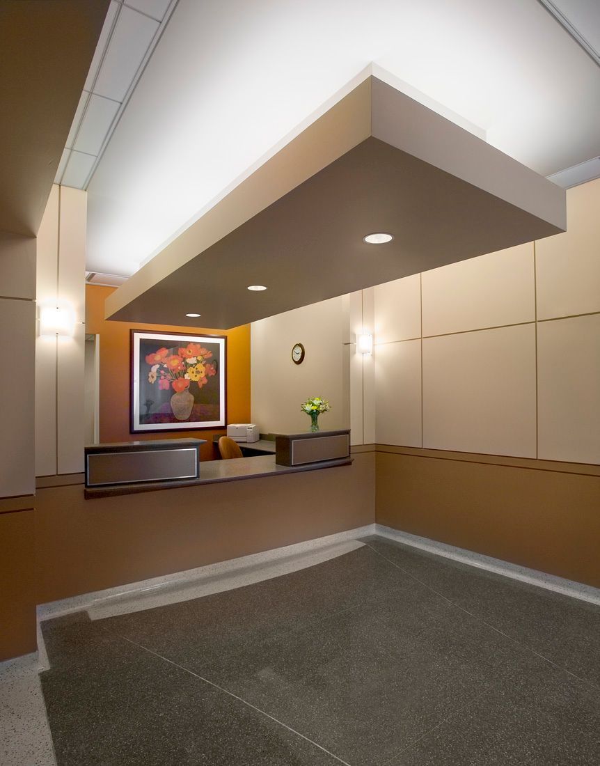 A reception area with a picture of flowers on the wall
