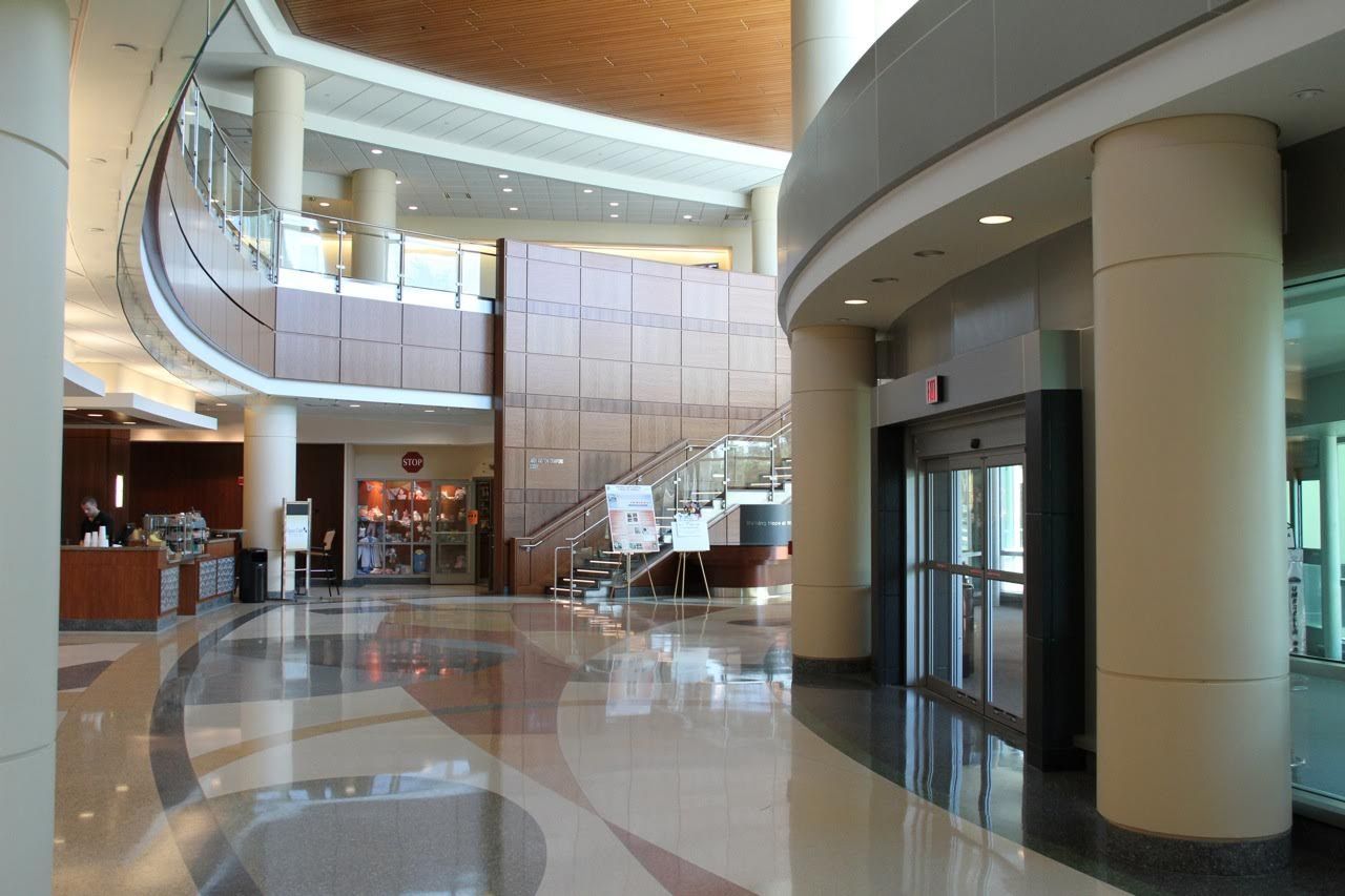 A large lobby with a staircase and elevator