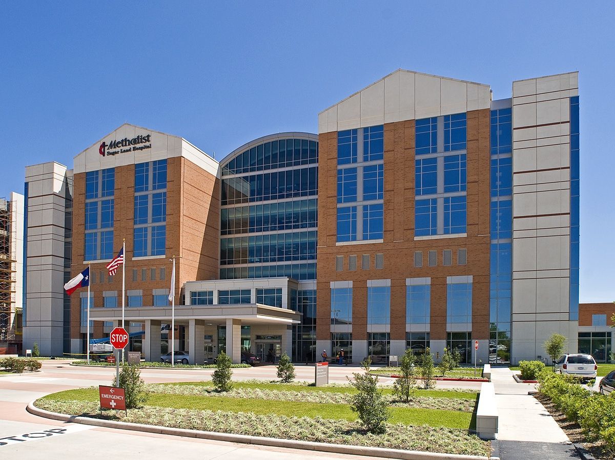 A large building with a lot of windows and a texas flag
