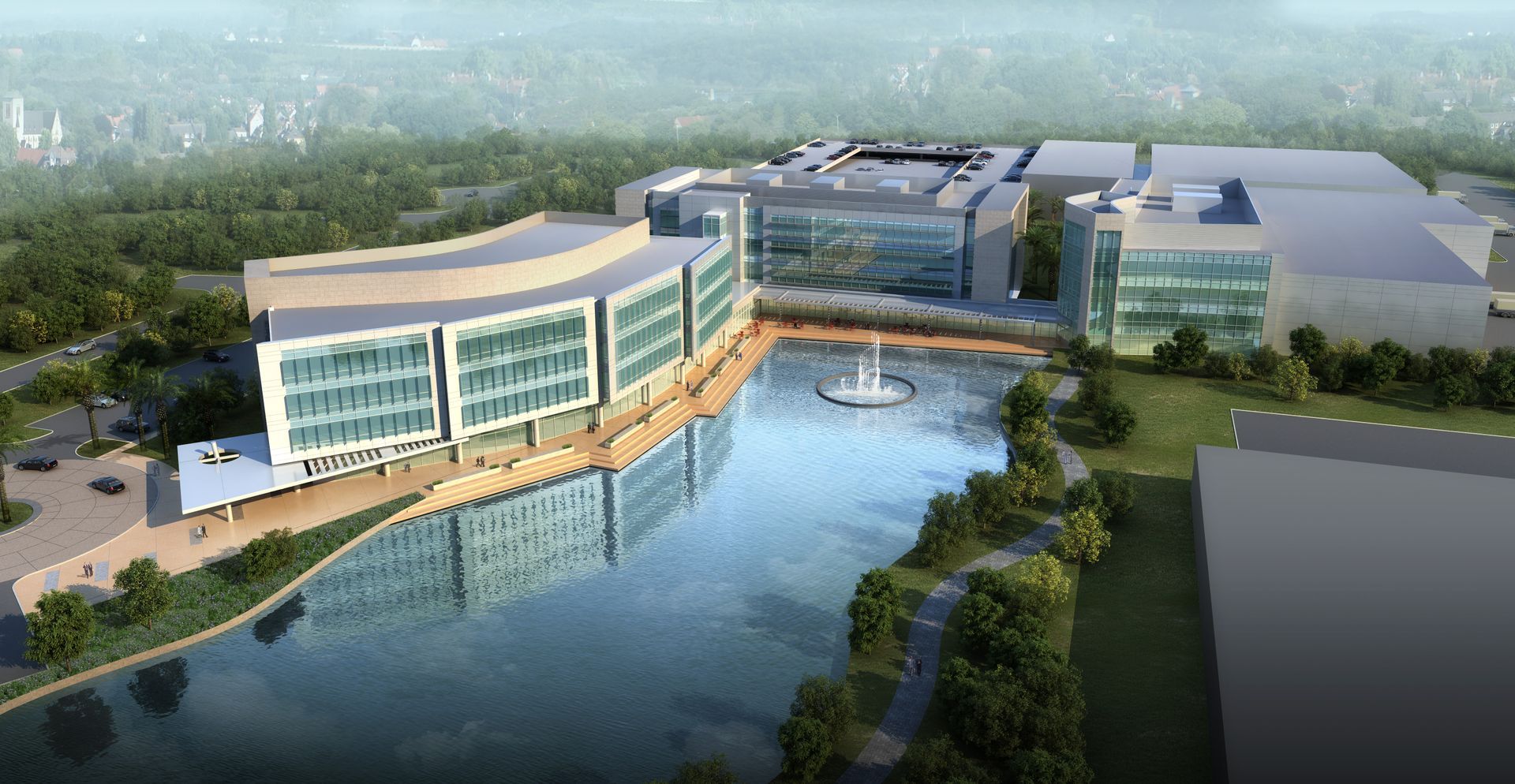 An aerial view of a large building next to a body of water