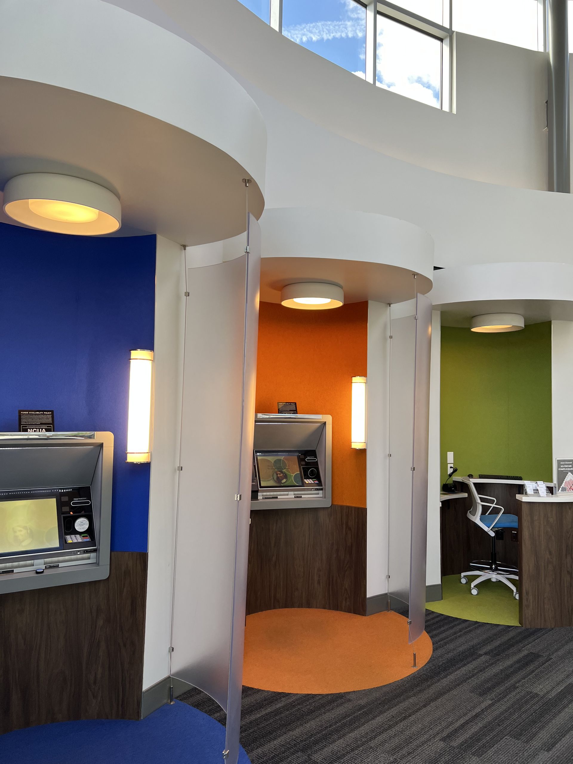 A row of atms are lined up in a room