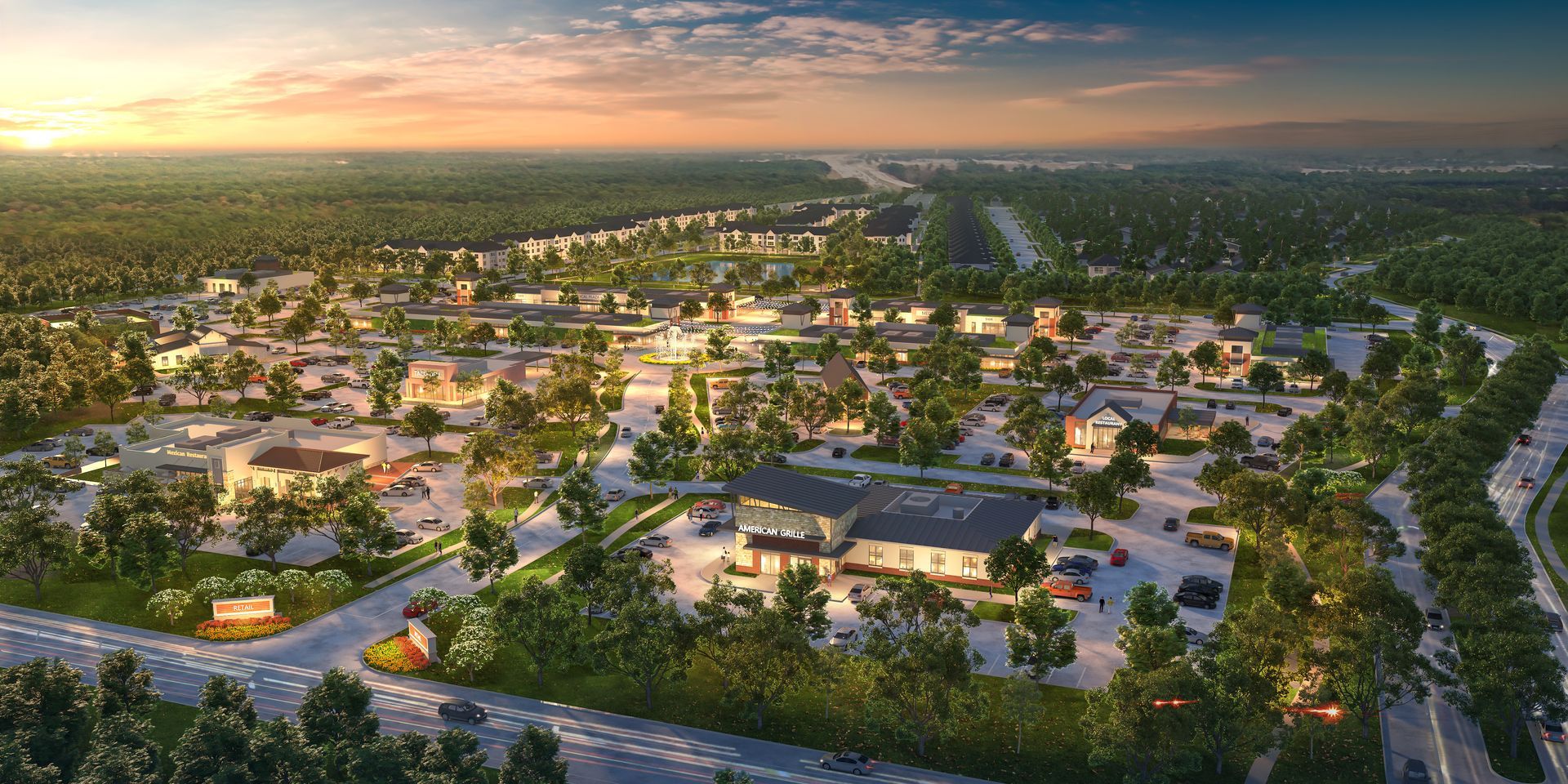 An aerial view of a small town surrounded by trees and a highway.