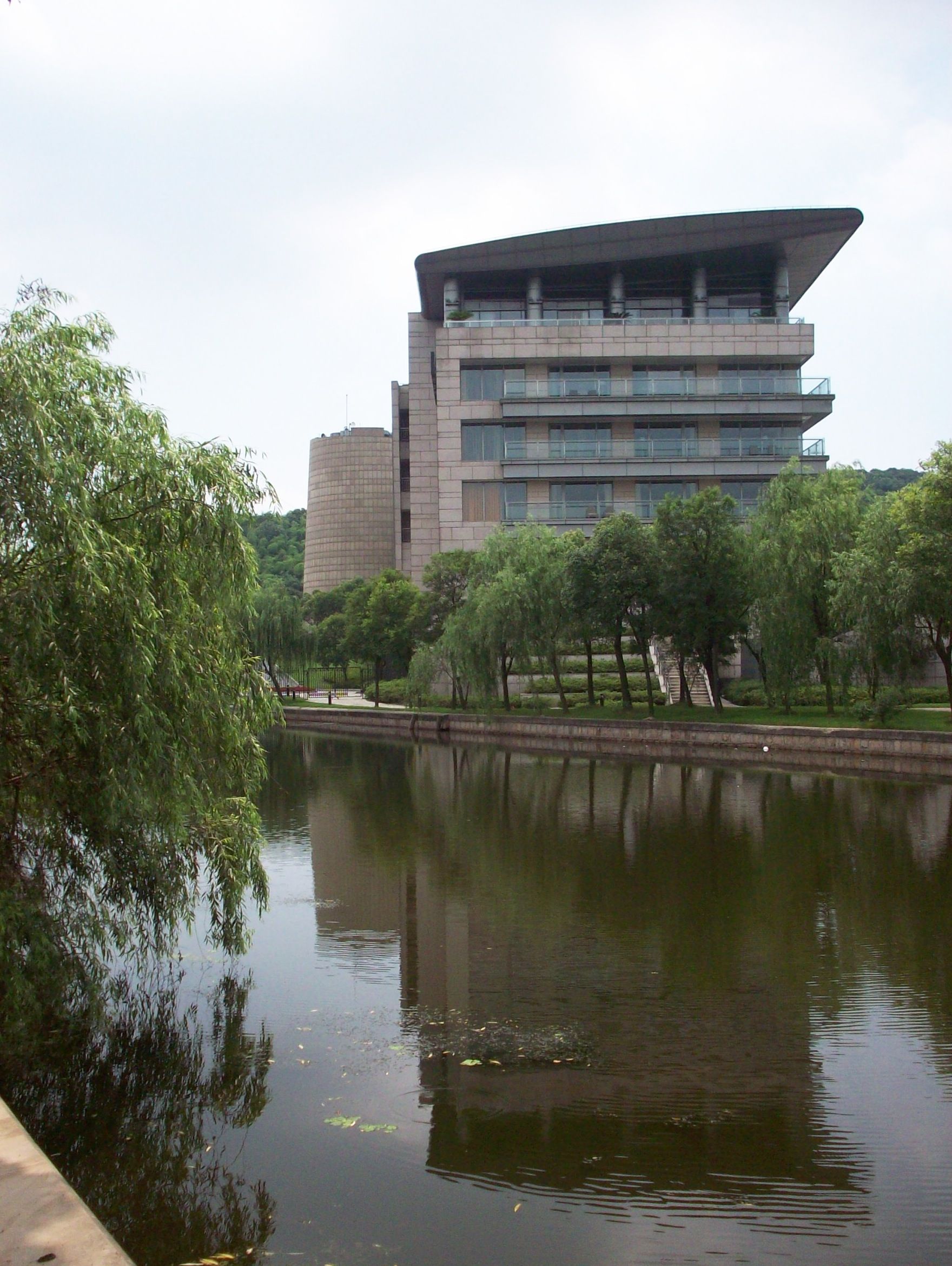 A large building is reflected in a body of water