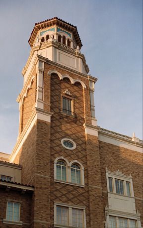 A tall brick building with a clock tower on top of it.