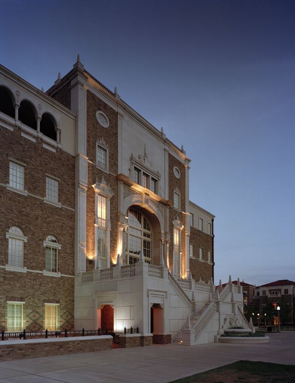 A large brick building with stairs leading up to it