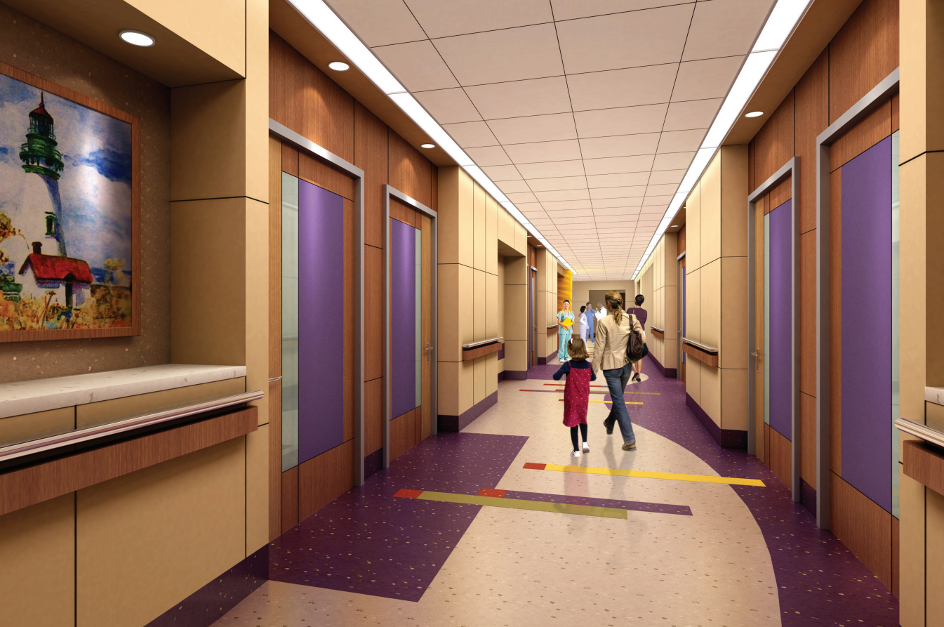 People are walking down a hospital hallway with purple doors