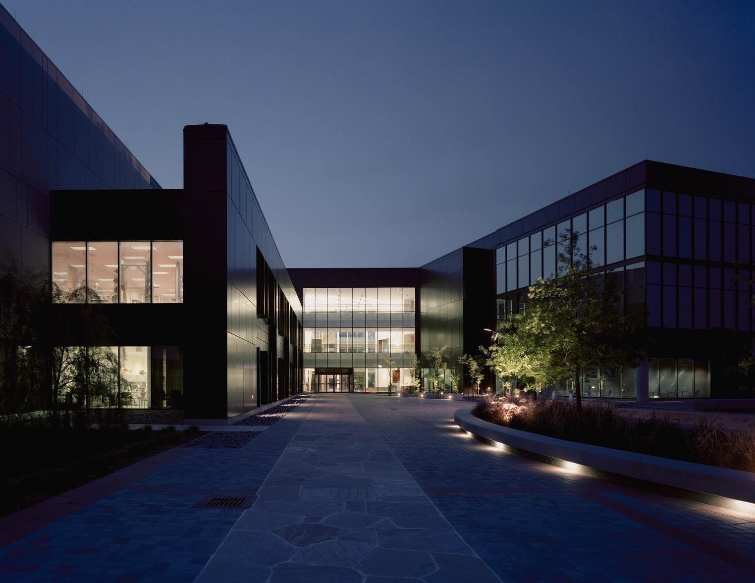 A large building with a lot of windows is lit up at night