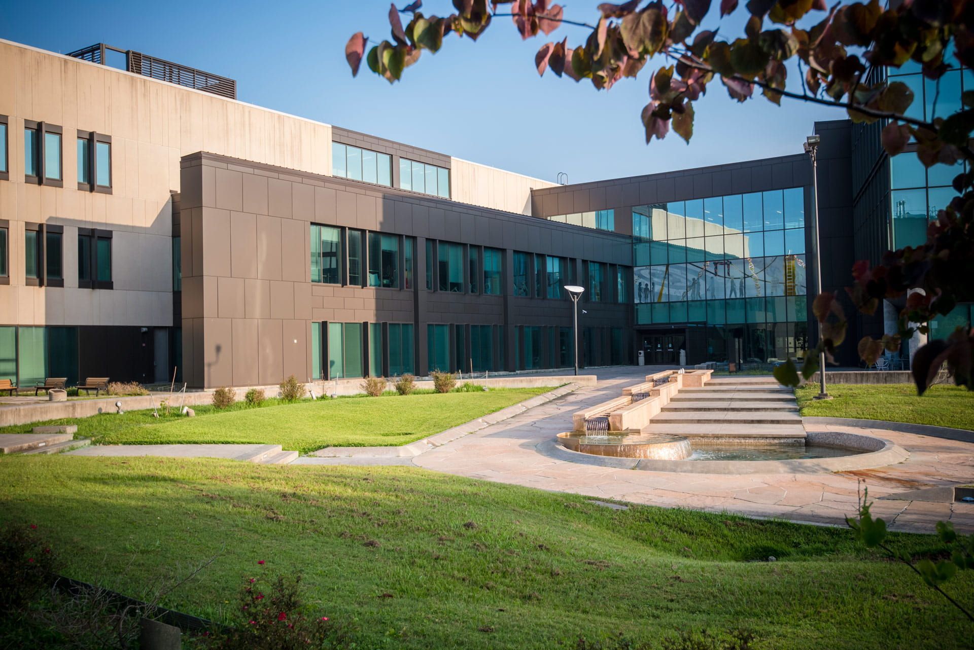 A large building with a fountain in front of it