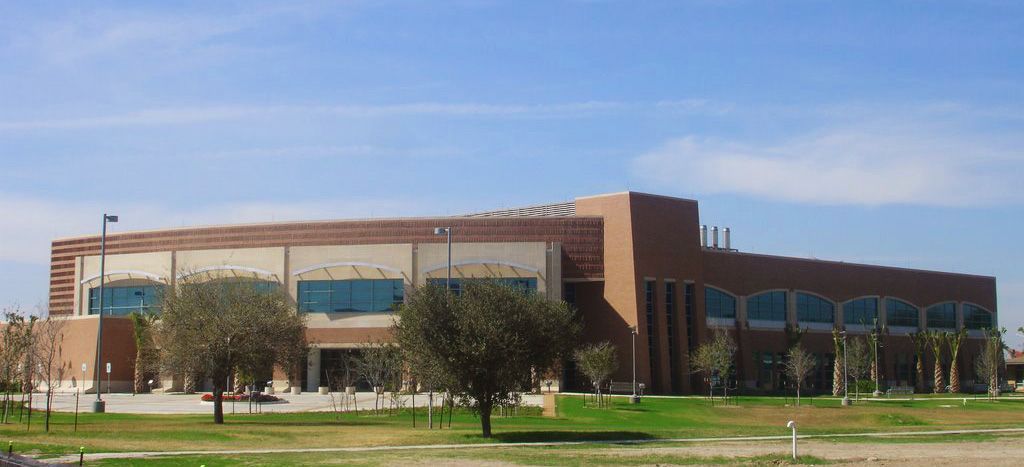 A large brick building with a blue sky in the background