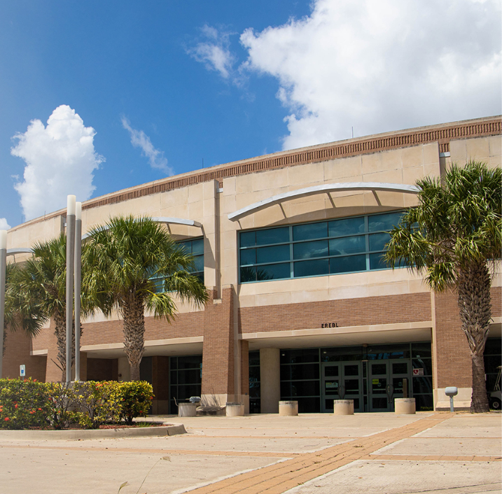 A large building with palm trees in front of it