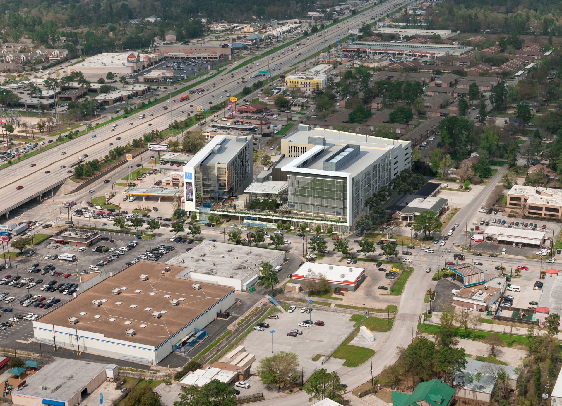 An aerial view of a city with a large building in the middle