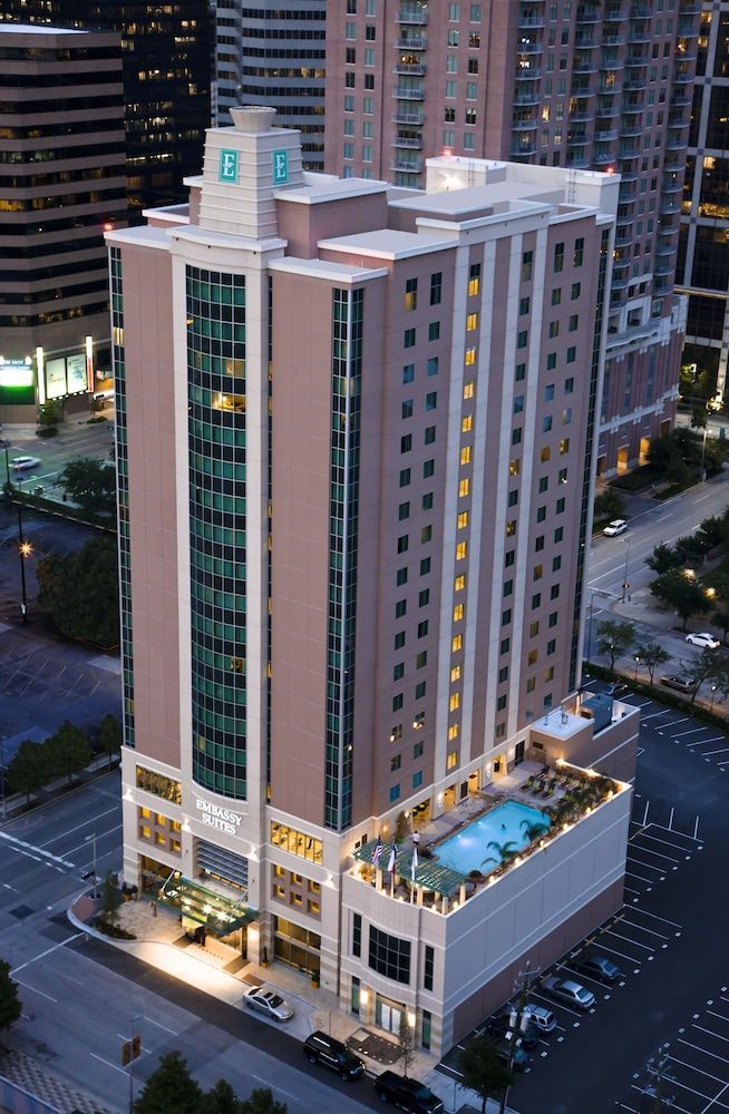 An aerial view of a hotel with a pool on the roof