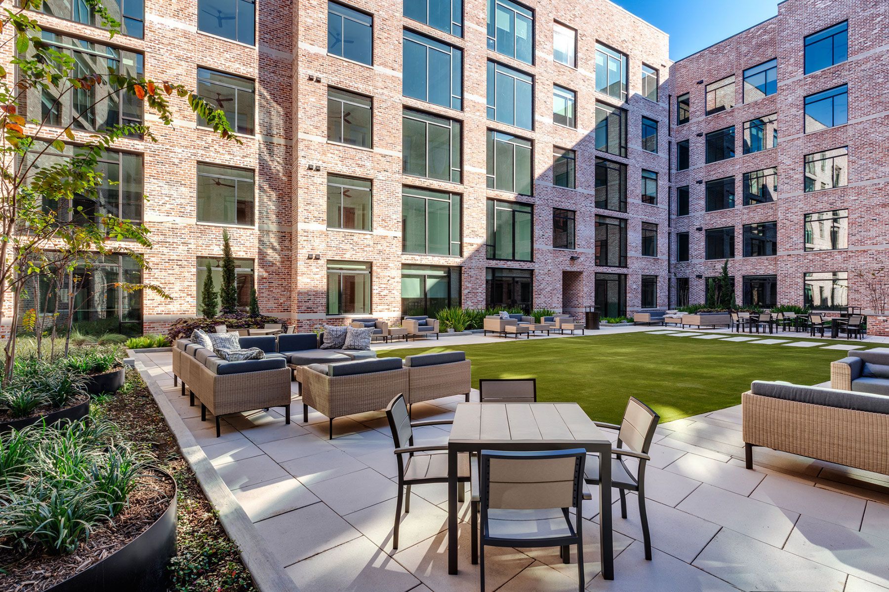 A large brick building with a patio area in front of it.