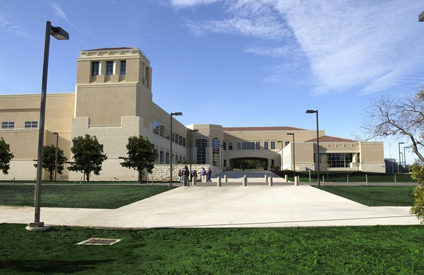 A large building with a concrete walkway leading to it