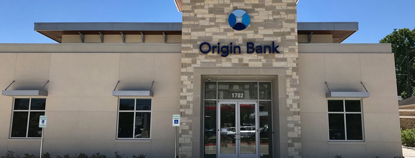 The front of an origin bank building with a blue sky in the background.
