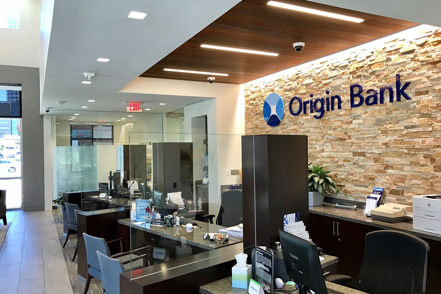 The inside of a bank with a sign that says origin bank.