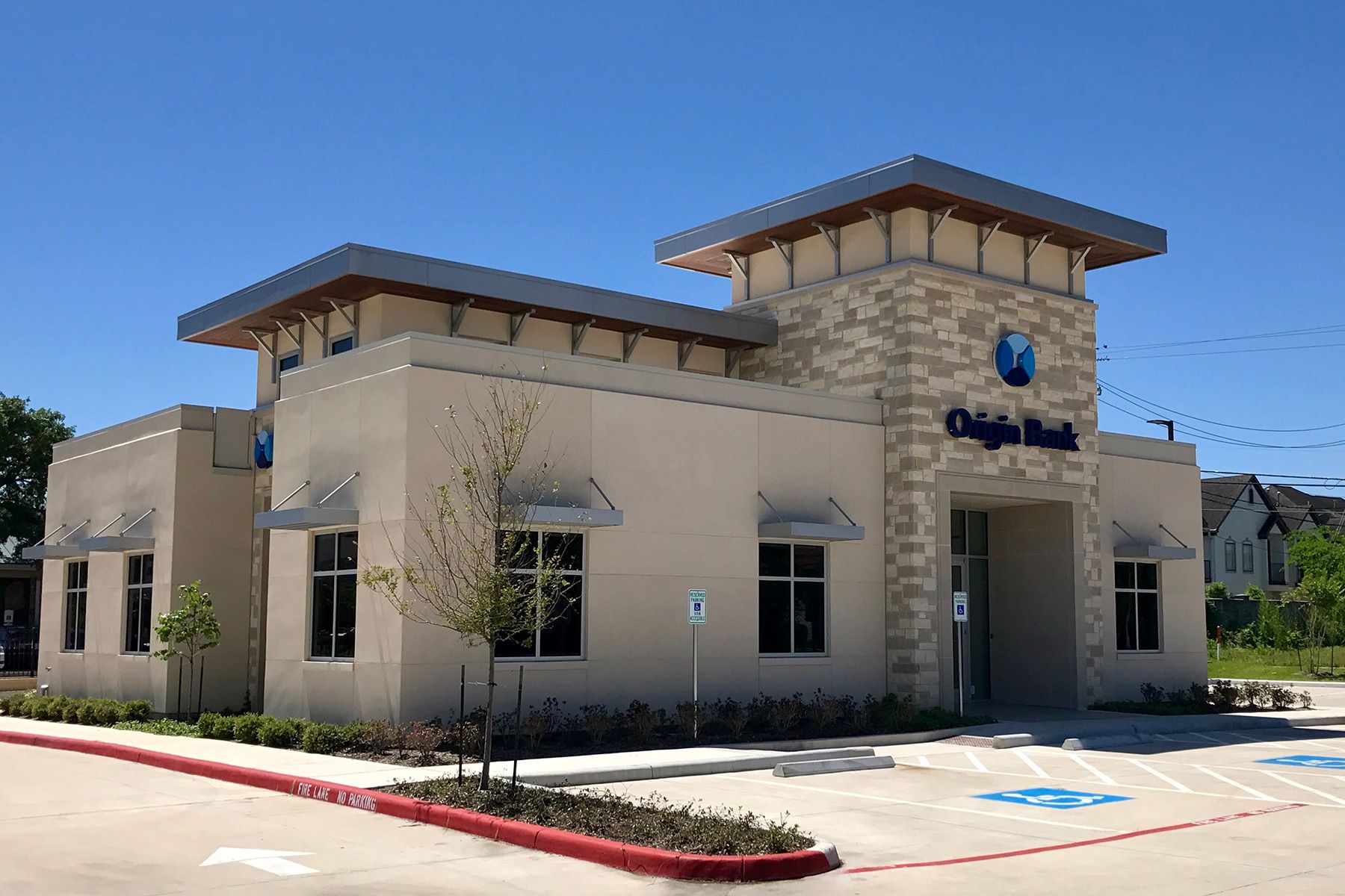 A bank building with a handicapped parking spot in front of it.