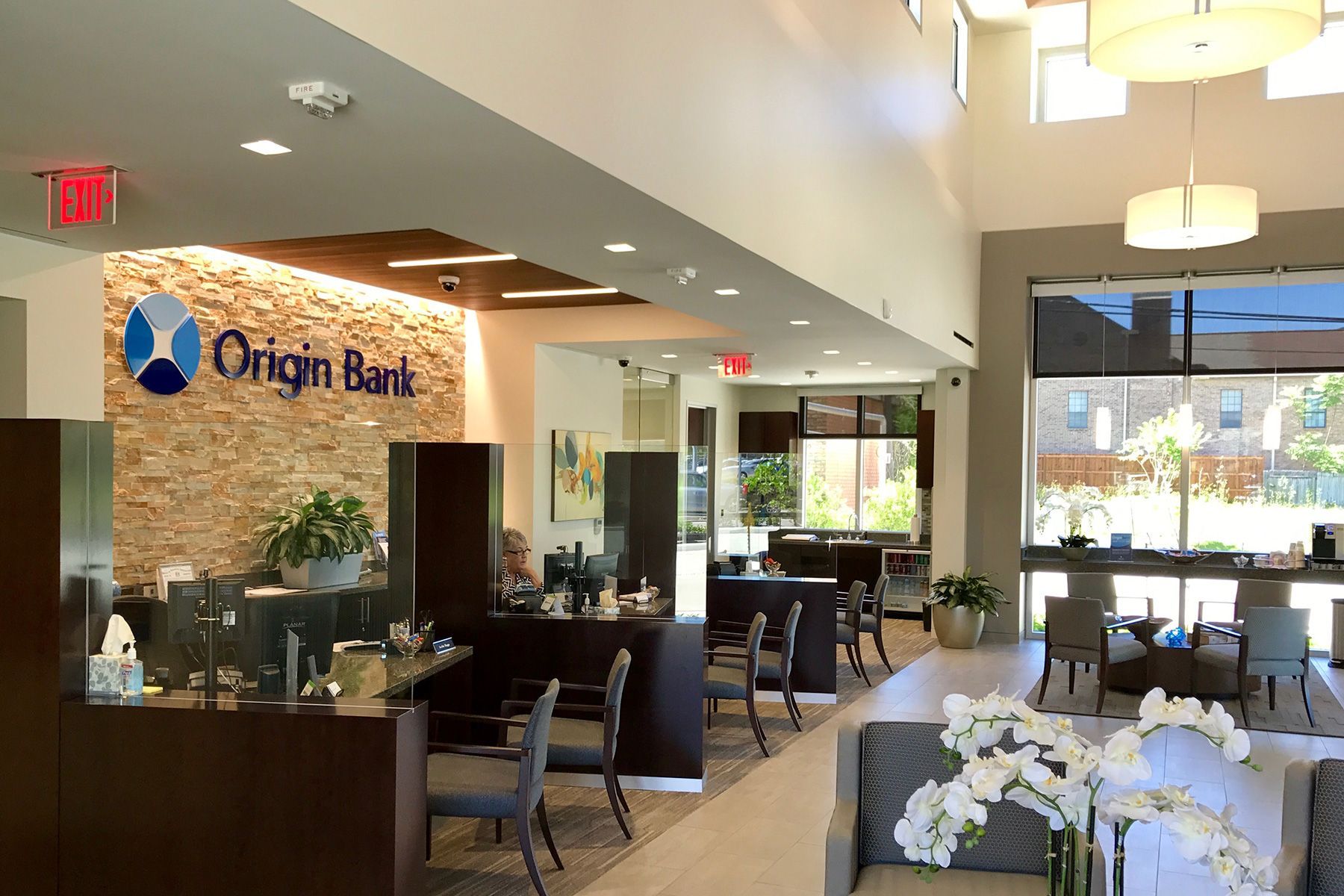 The inside of a bank with a sign that says origin bank