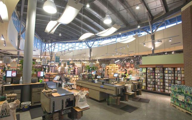 The inside of a grocery store with a ceiling that is very high.
