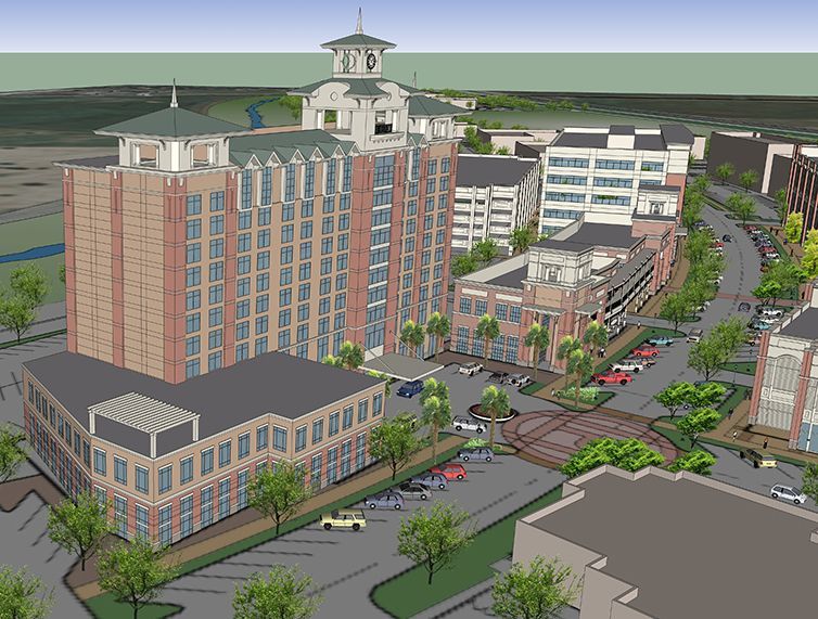 An aerial view of a city with a large brick building in the middle.