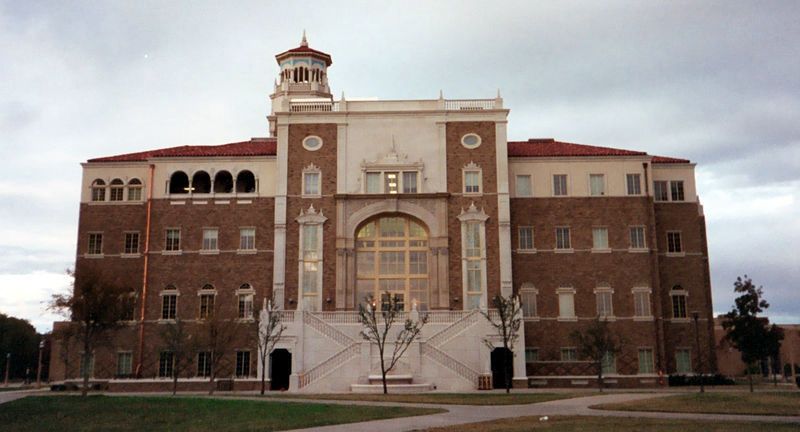 A large brick building with stairs leading up to it