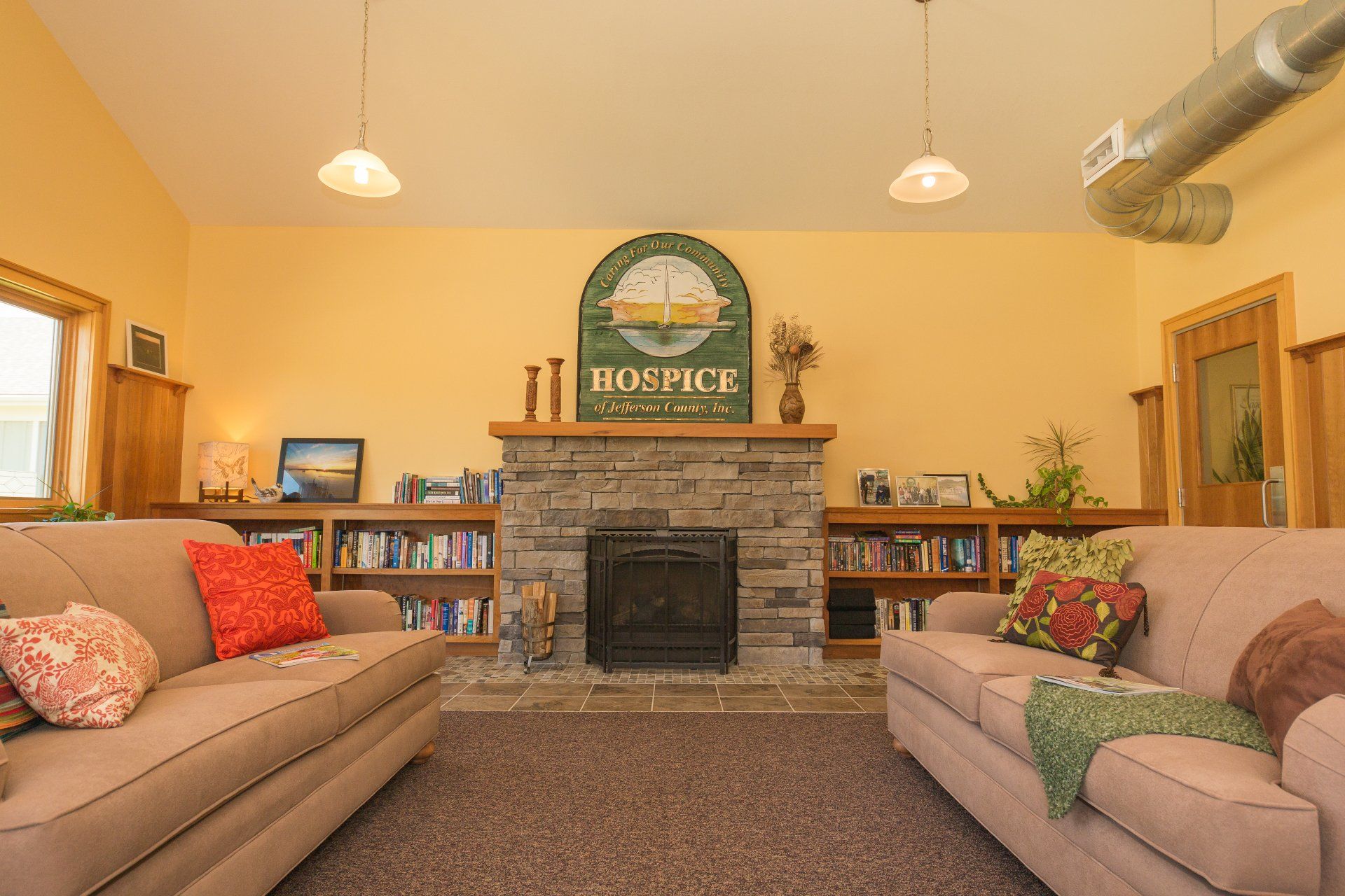 A living room with two couches and a fireplace.