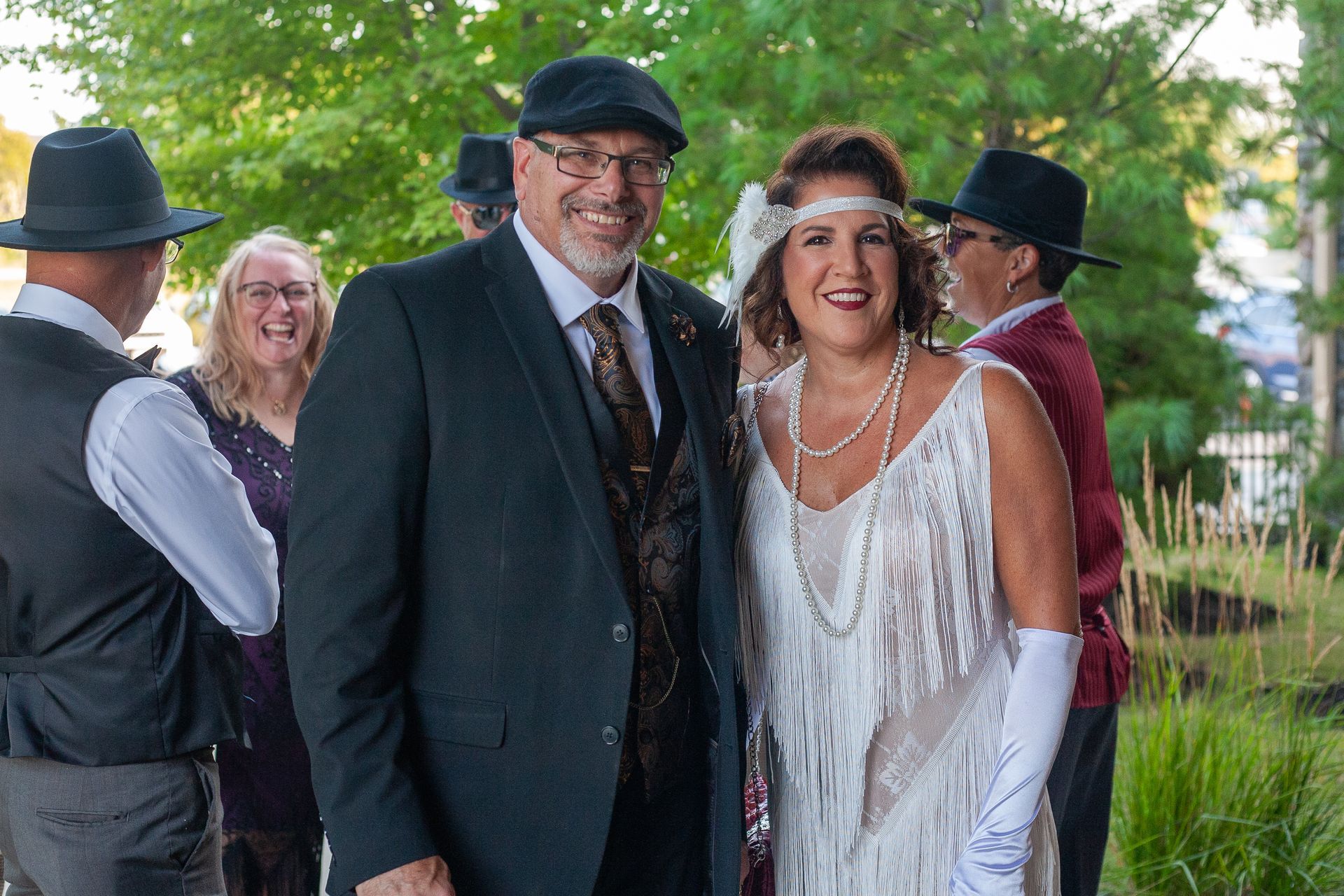 A man and a woman are posing for a picture while standing next to each other.
