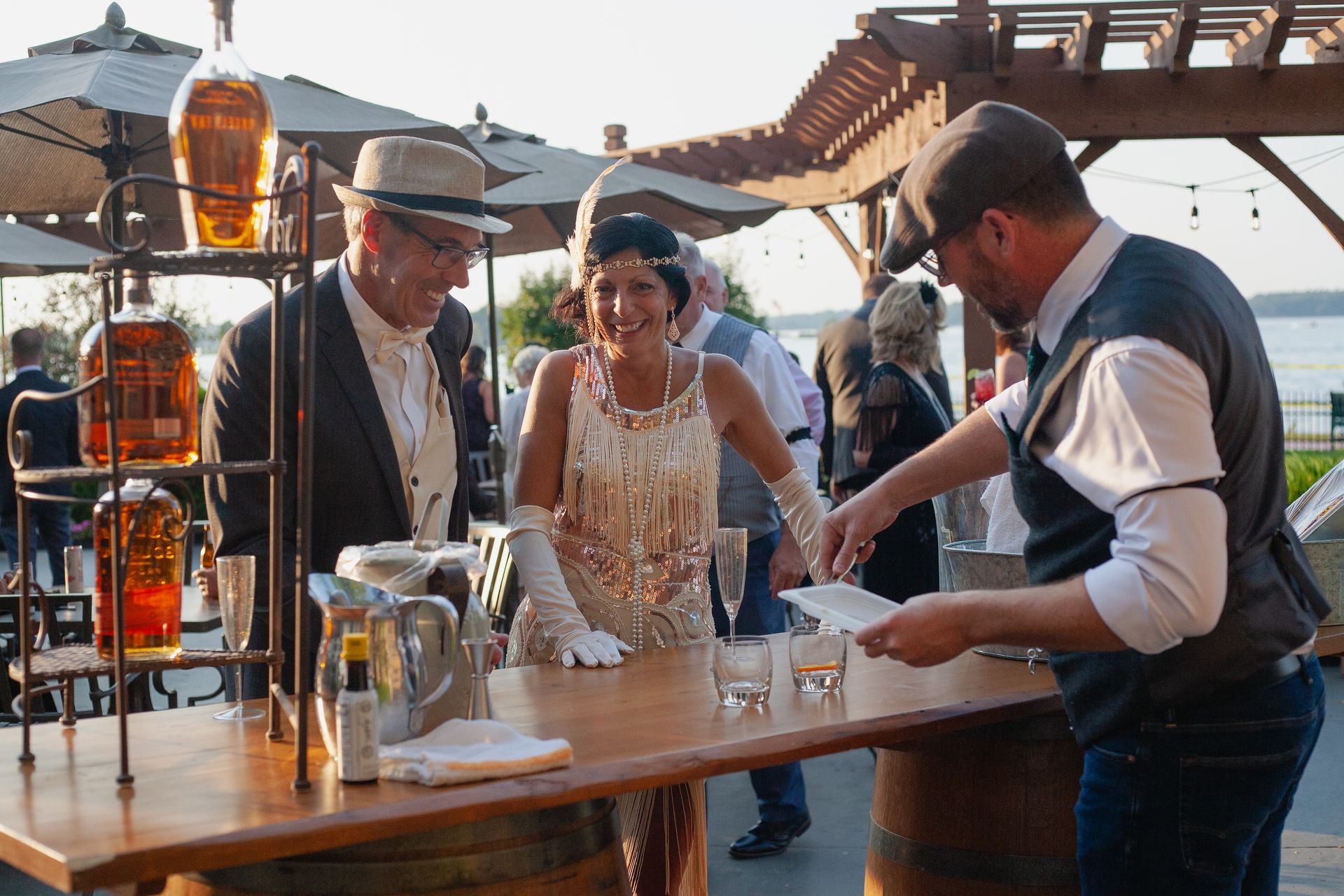 A group of people are standing around a wooden table.