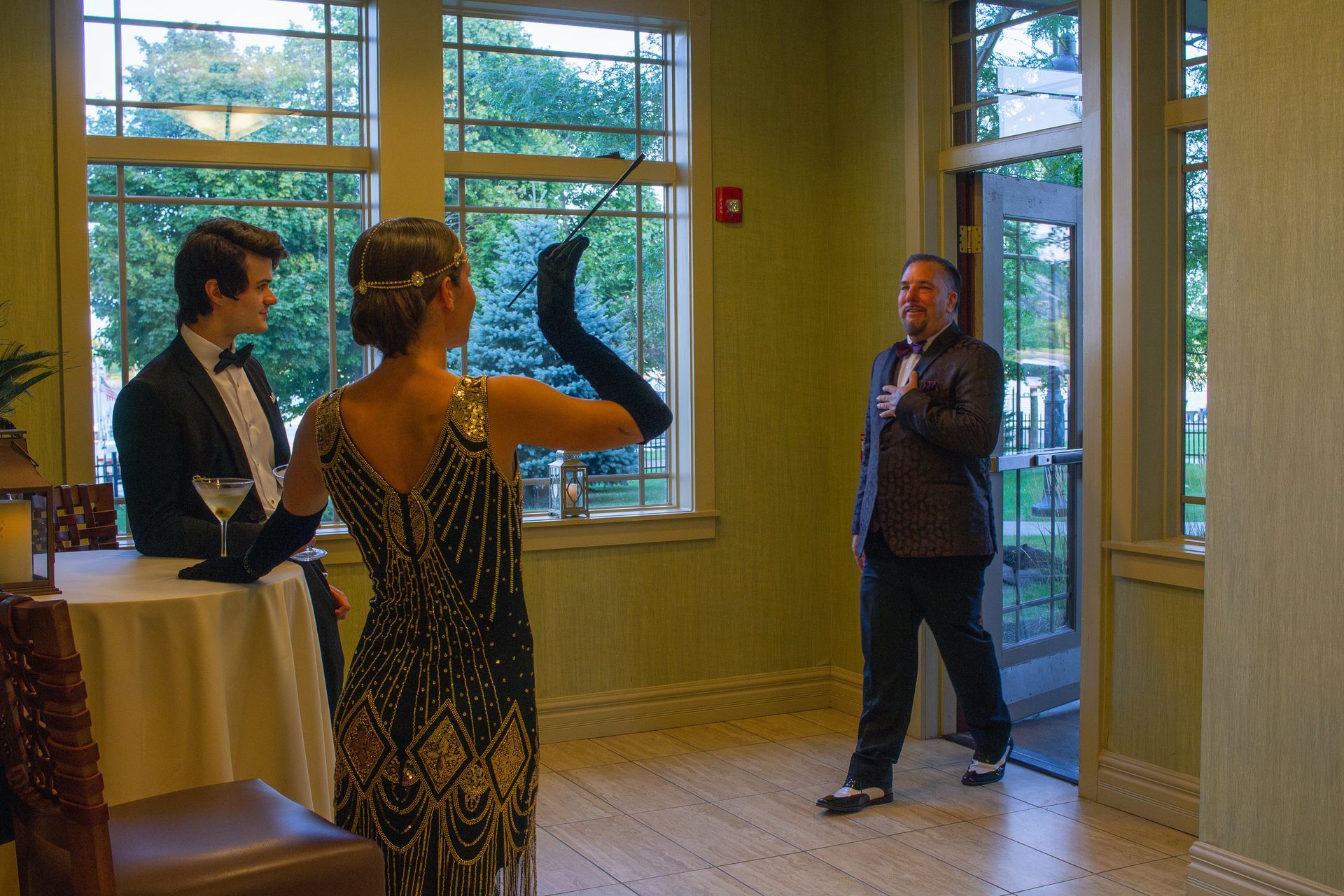 A man in a tuxedo stands next to a woman in a dress