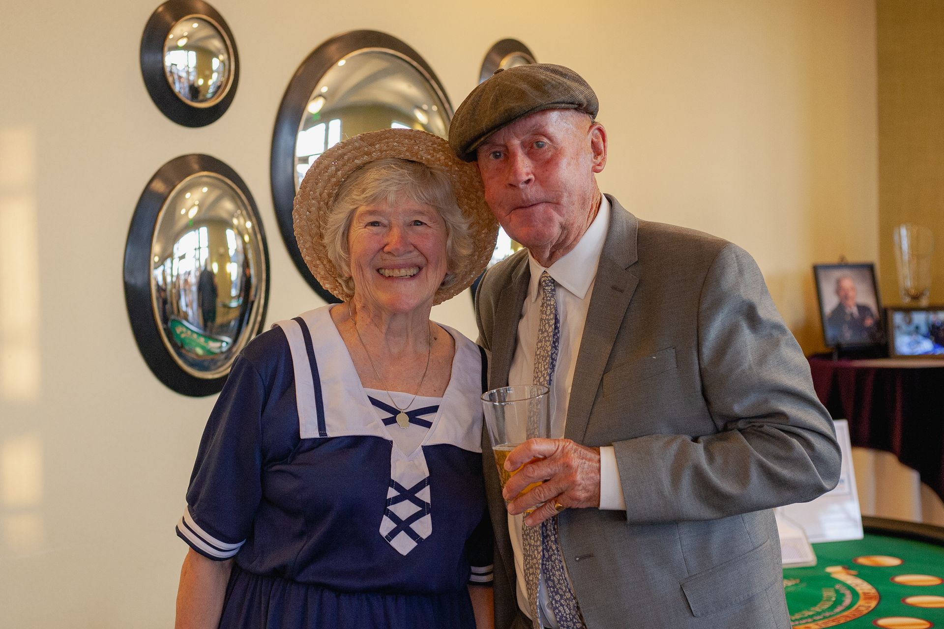 A man and a woman are posing for a picture while holding glasses of champagne.