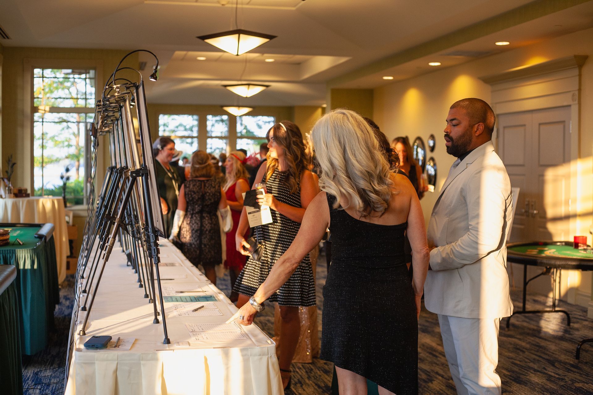 A group of people are standing around a table in a room.