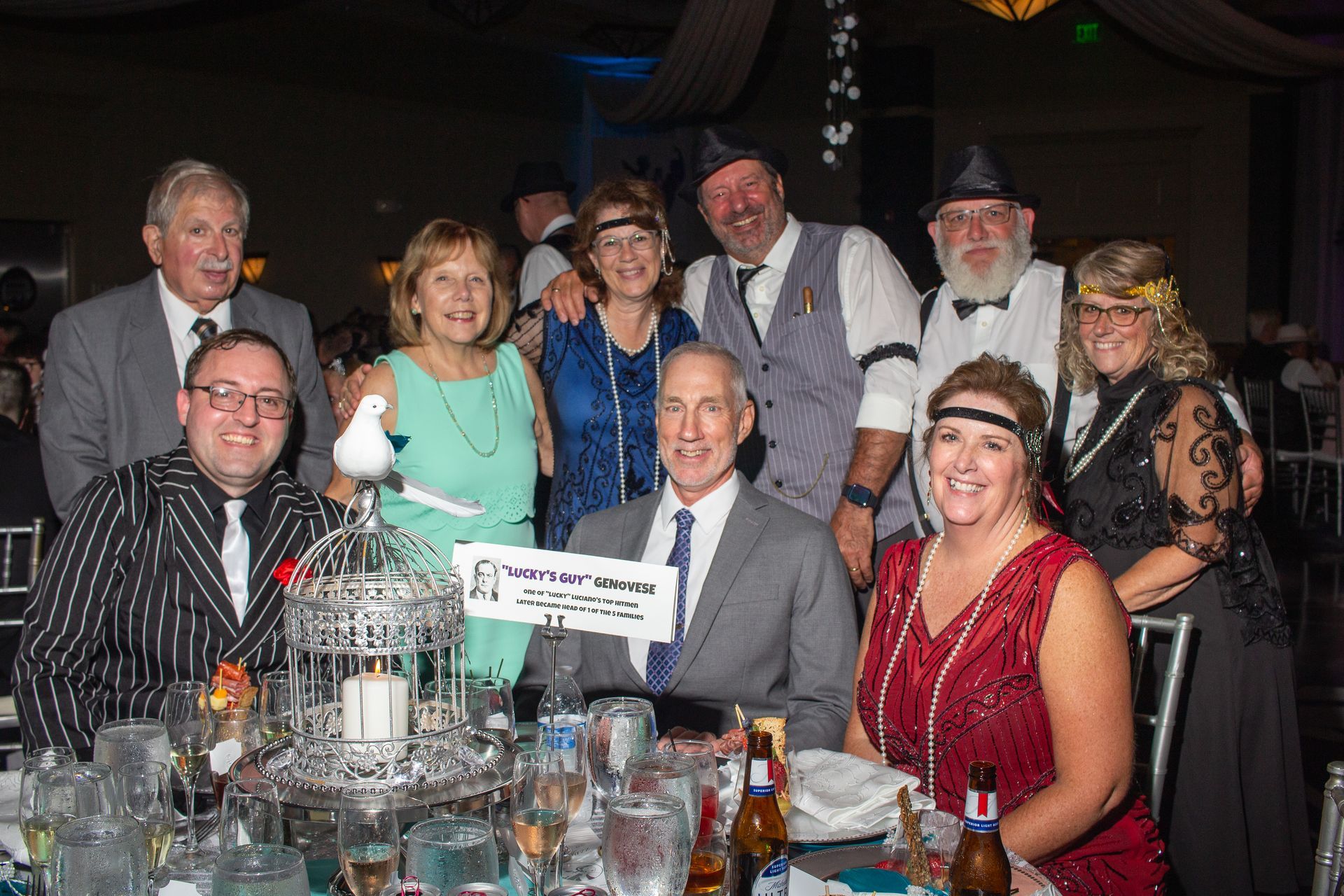 A group of people are posing for a picture at a table at a party.