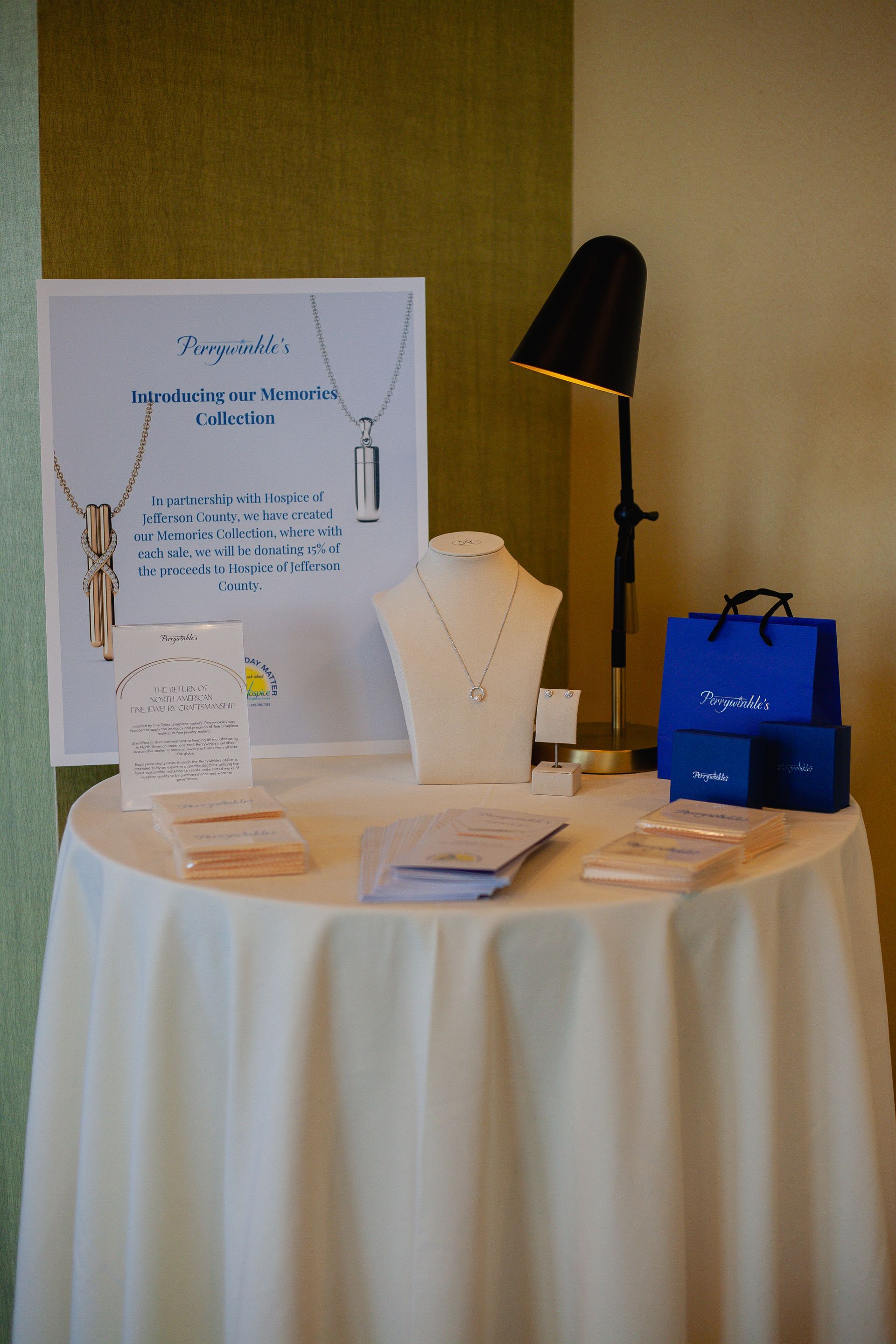 A table with a white table cloth and jewelry on it