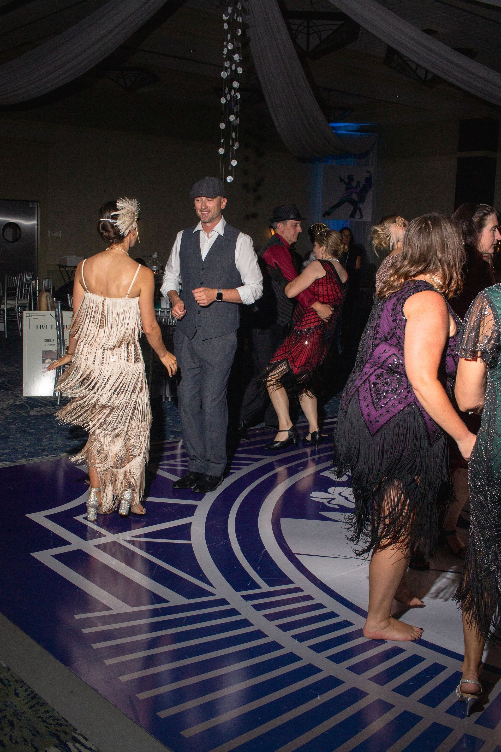 A group of people are dancing on a dance floor.
