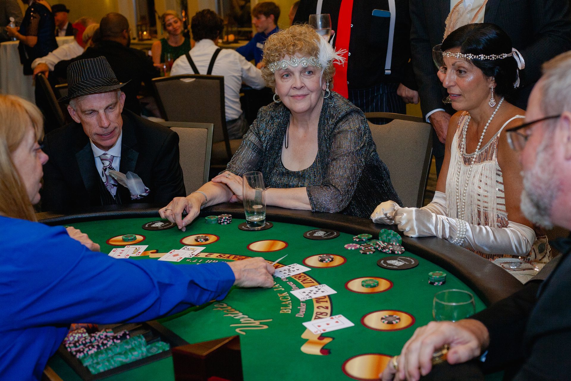 A group of people are playing a game of blackjack at a table.