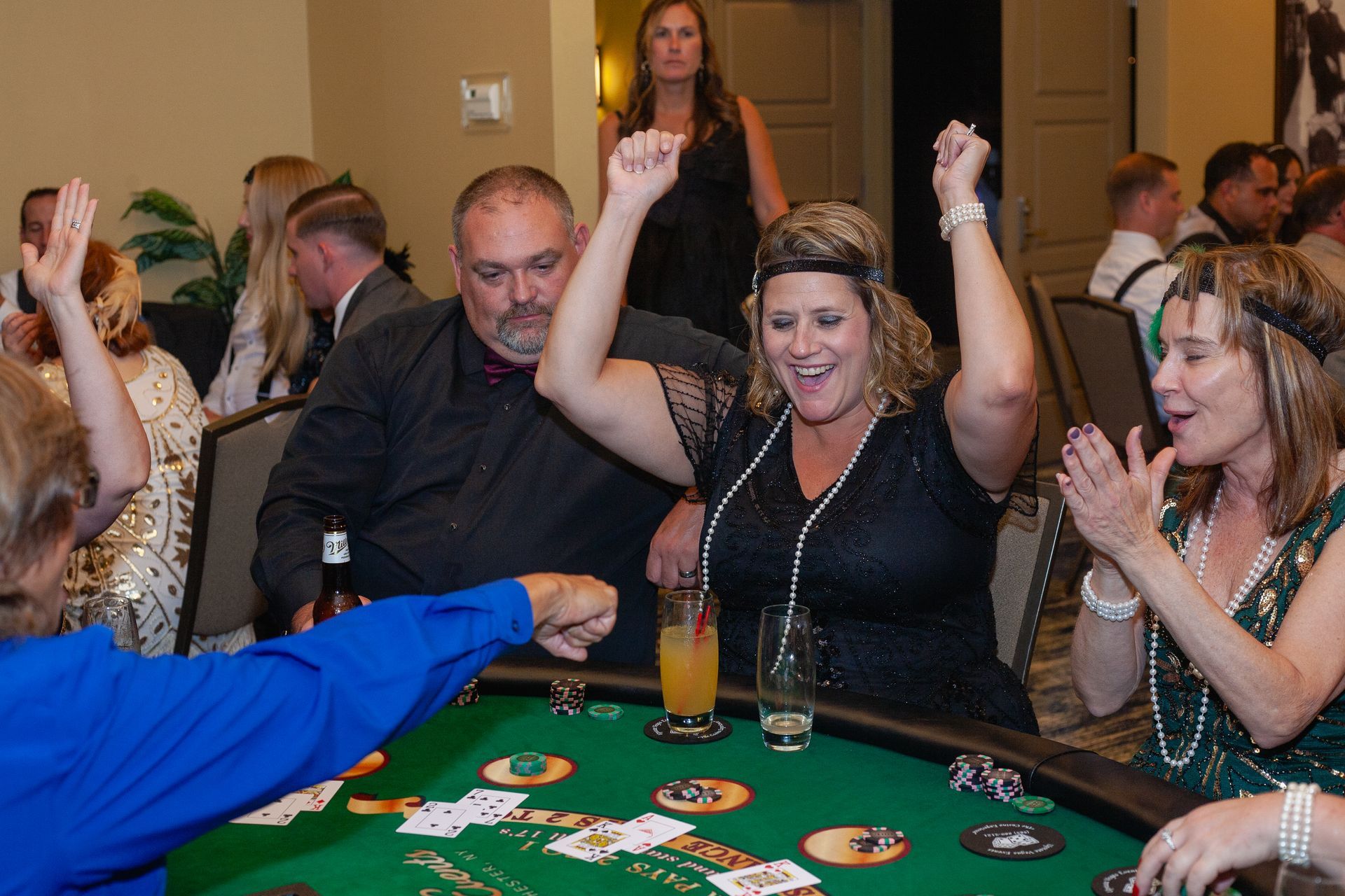 A group of people are playing a game of cards at a table.