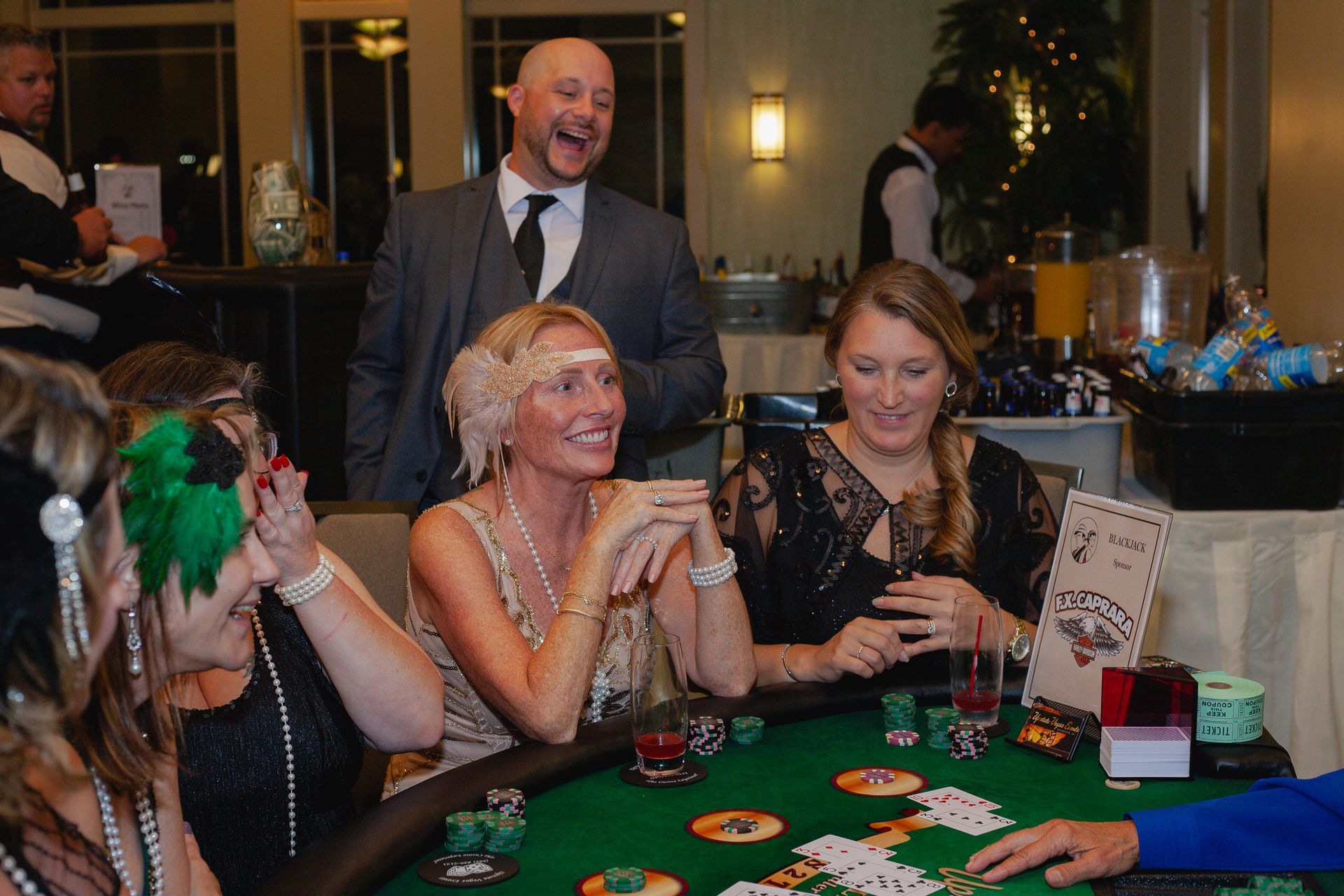 A group of people are sitting at a table playing poker.