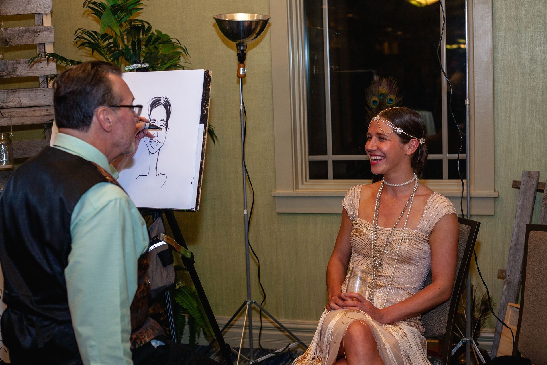 A man is drawing a picture of a woman on an easel