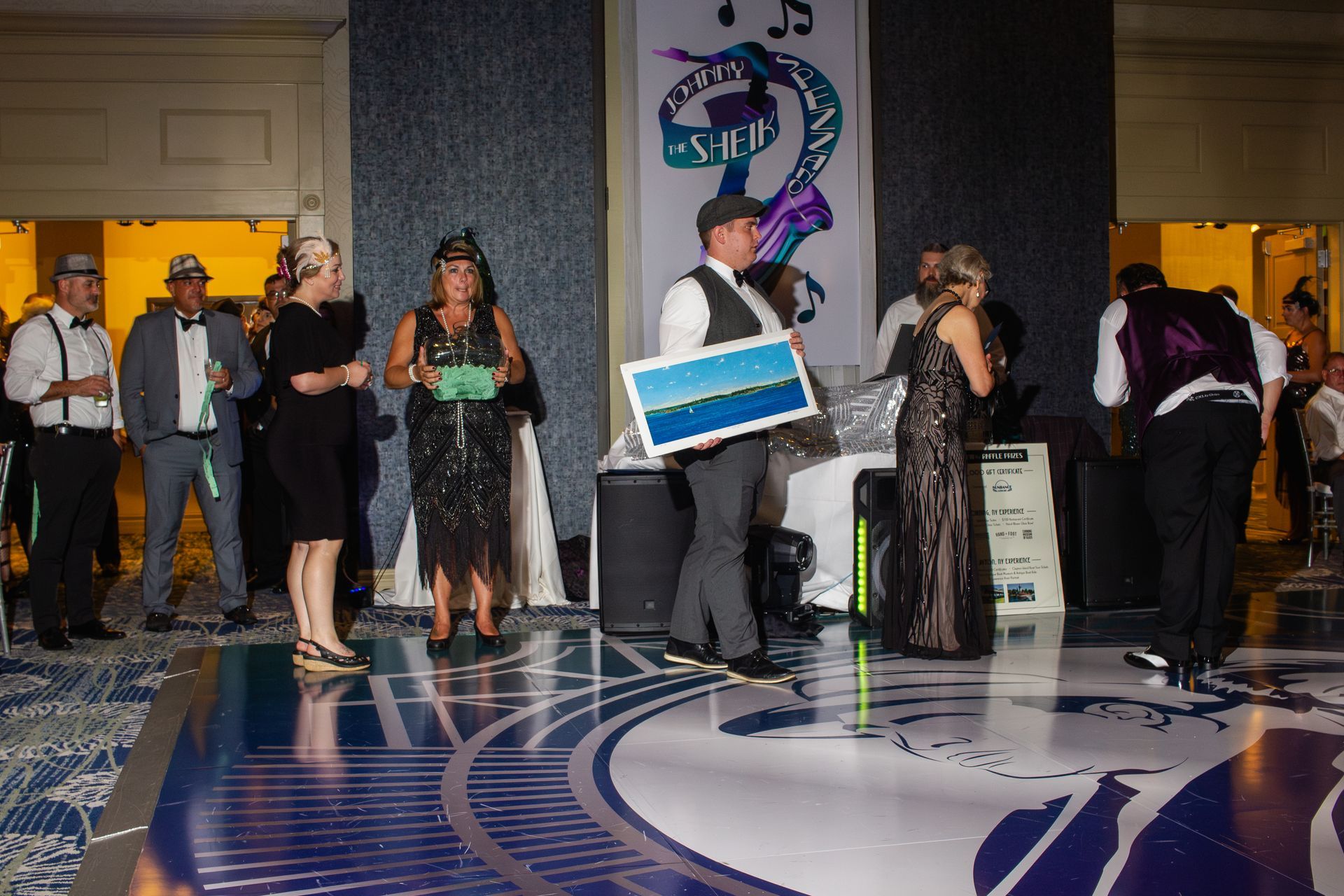 A group of people are standing on a dance floor at a party.