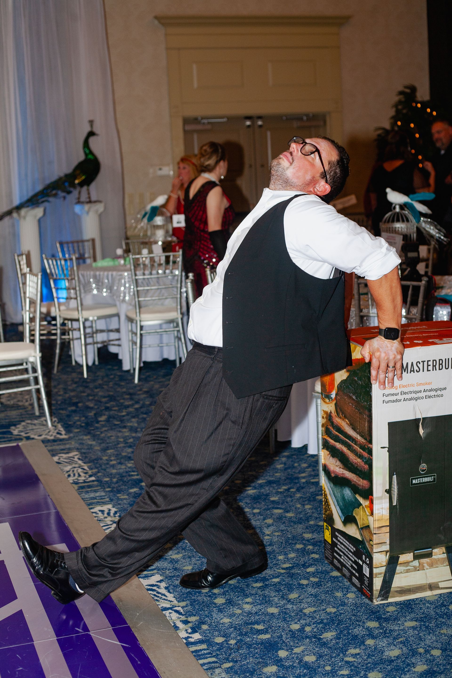 A man is leaning on a box that says ' a ' on it