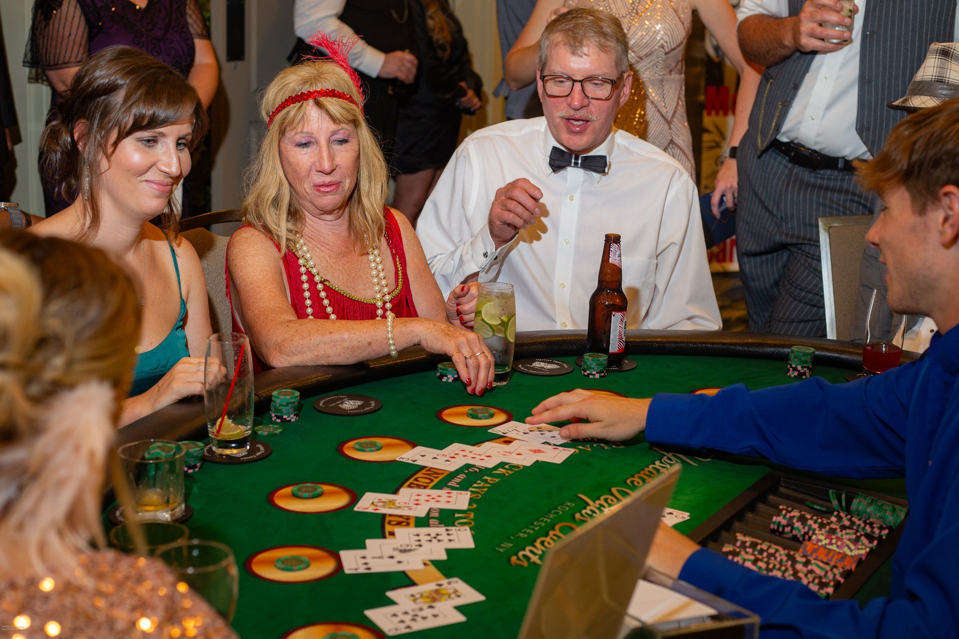 A group of people are playing a game of poker at a table.