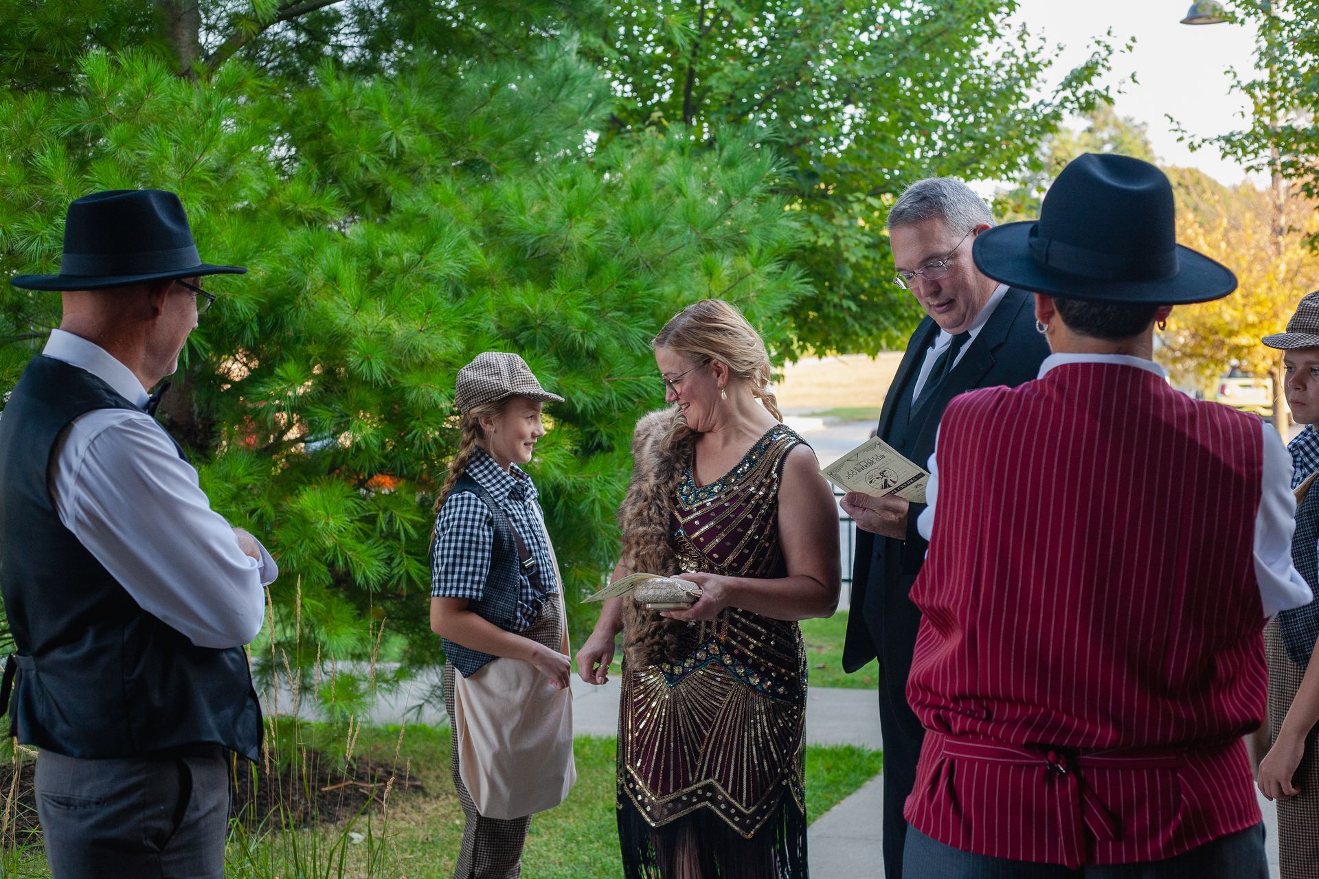 A group of people are standing in a circle talking to each other.