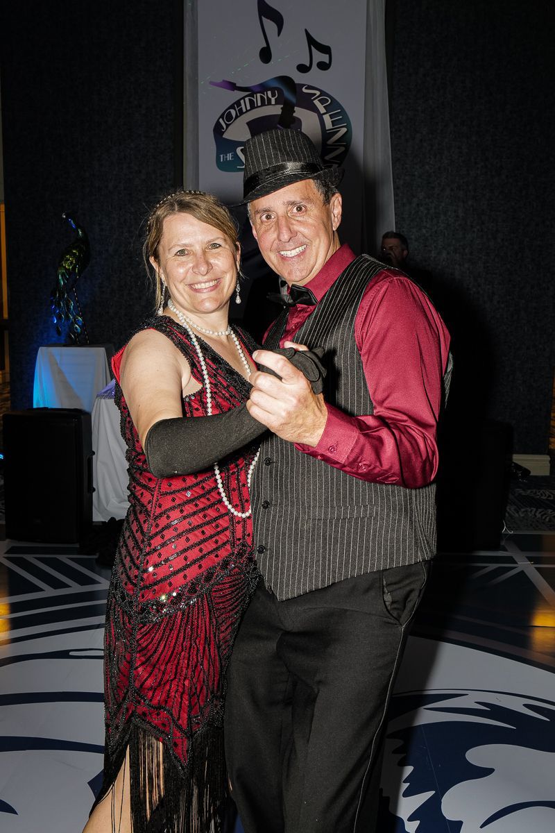 A man and a woman are dancing together in a room.