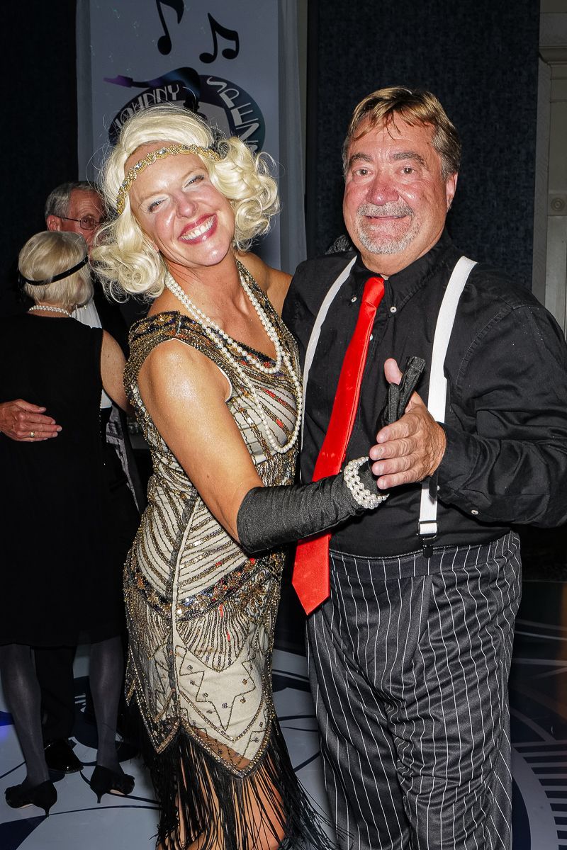 A man and a woman are posing for a picture at a party