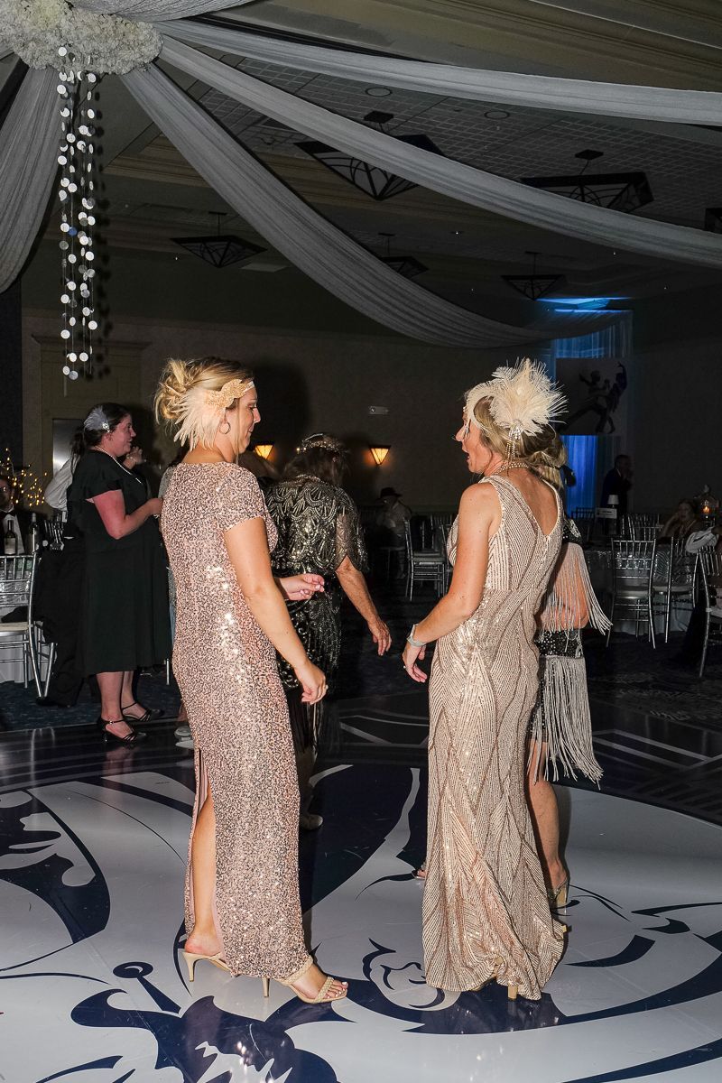 A group of women are dancing on a dance floor at a party.
