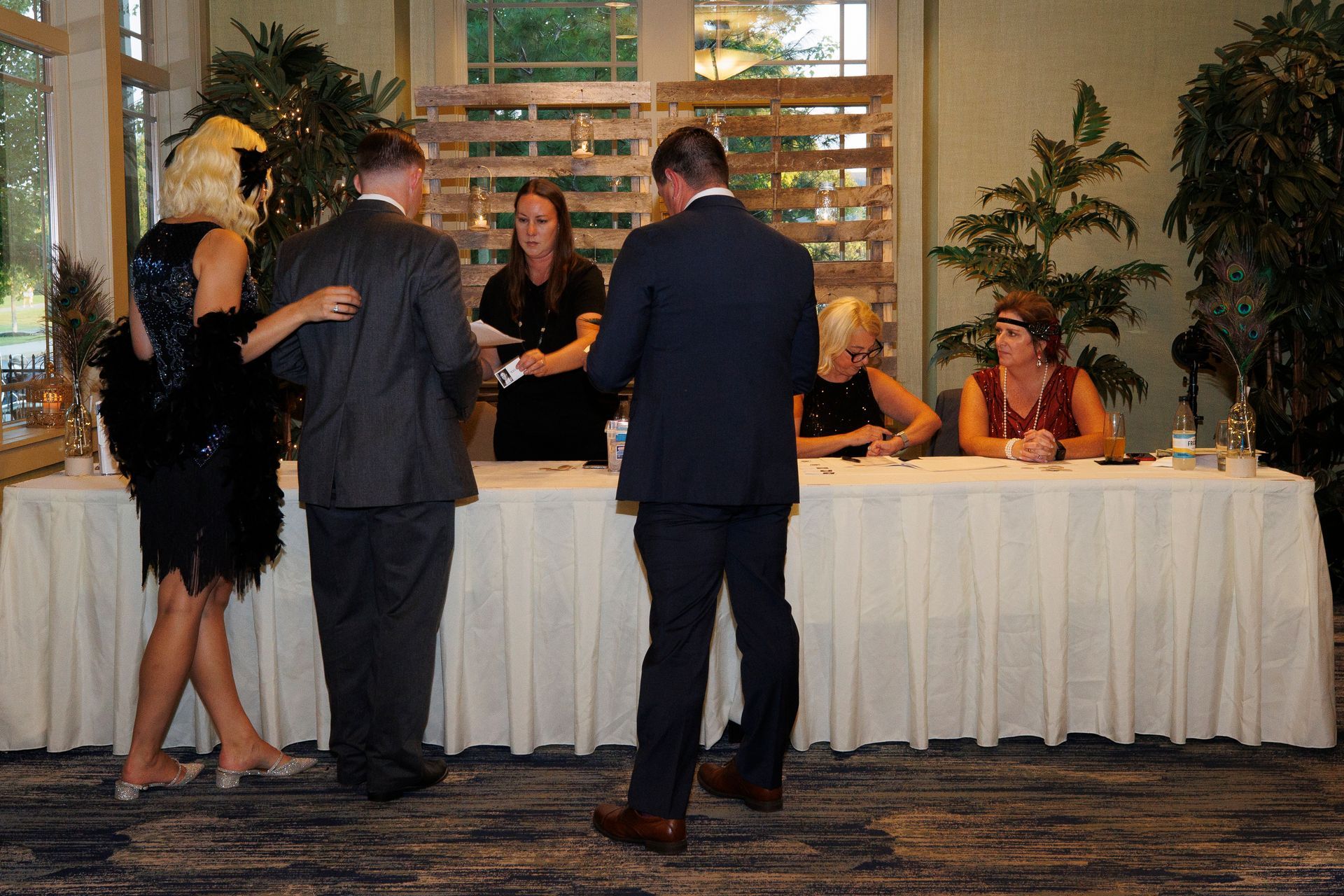 A group of people standing around a table in a room