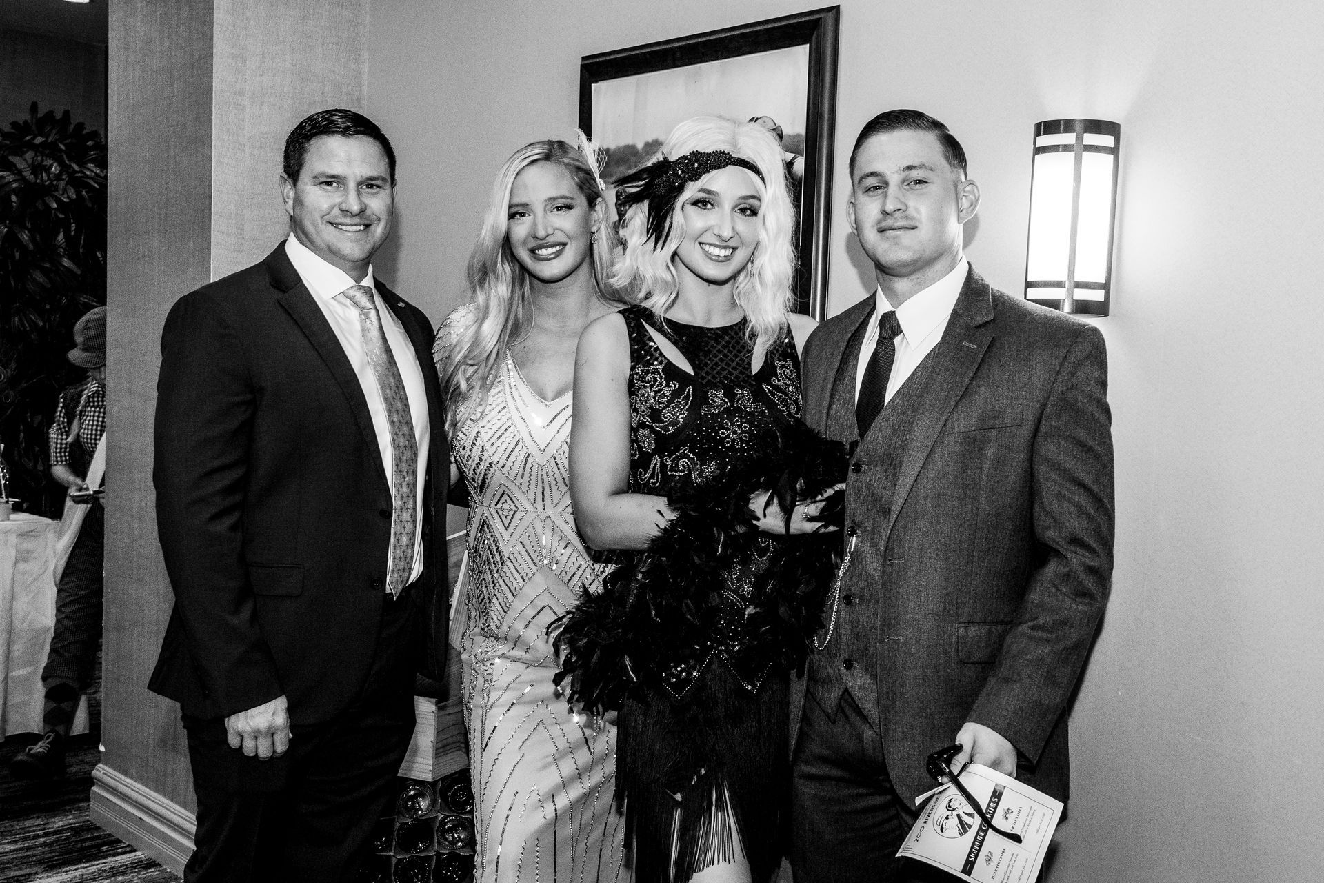 A group of people are posing for a picture in a black and white photo.