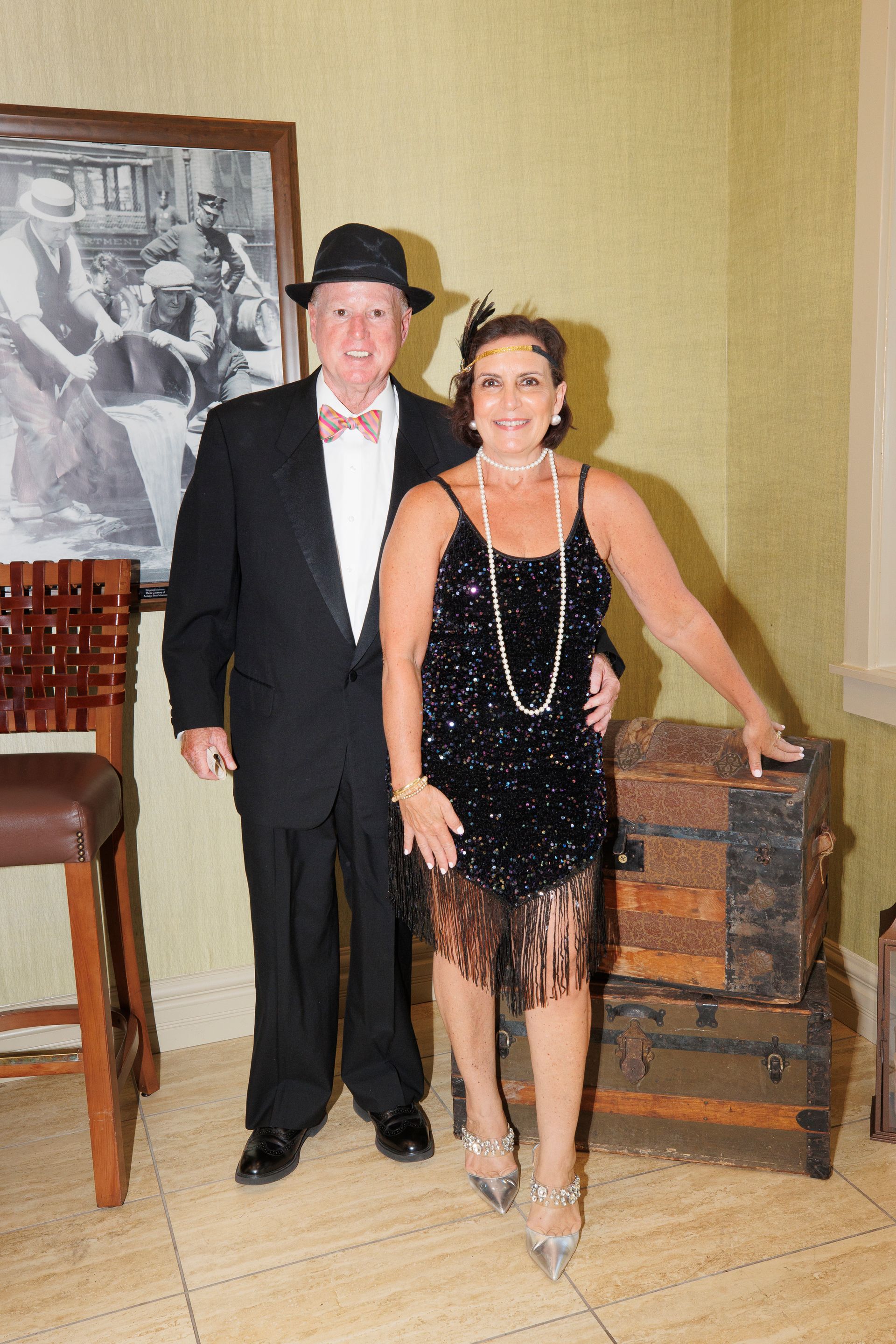 A man in a tuxedo and a woman in a dress are posing for a picture.