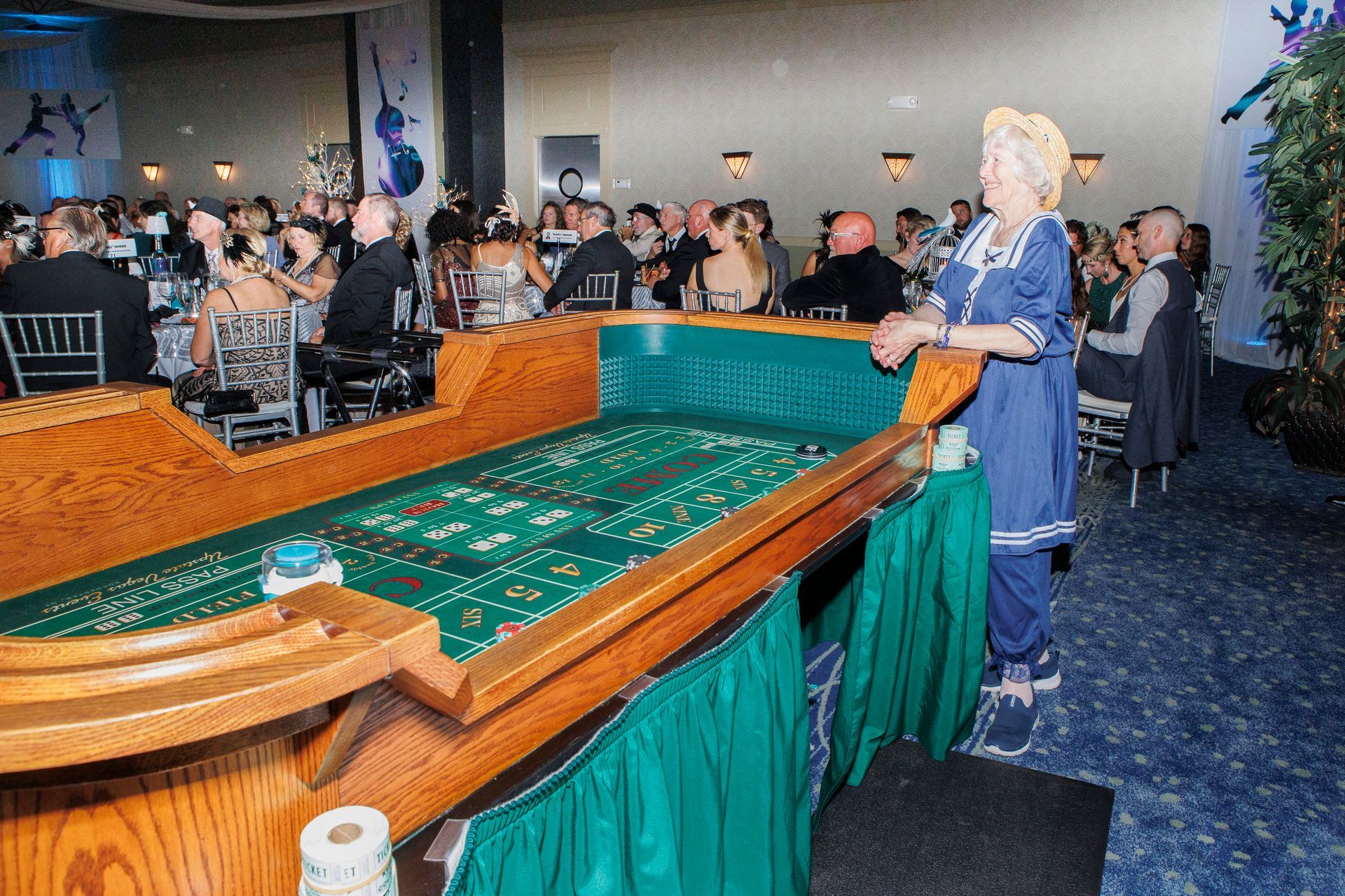 A woman is standing in front of a roulette table